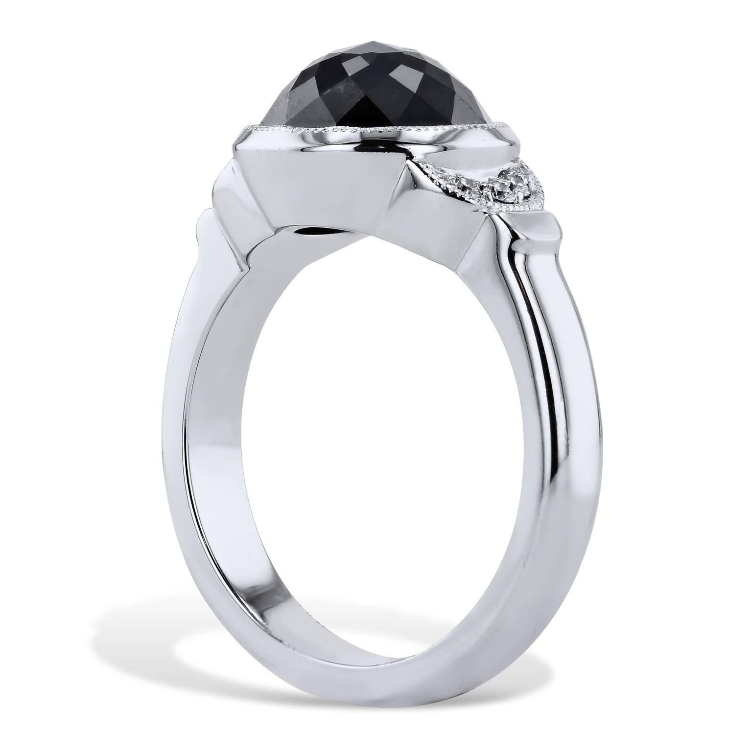 This 18 karat white gold handmade black and white diamond ring conjures the thought of the night sky punctuated by moonlight. A 4.00 carat rose cut black diamond is bezel-set at center and feature 0.06 carat of pave diamond in crescent moon shape