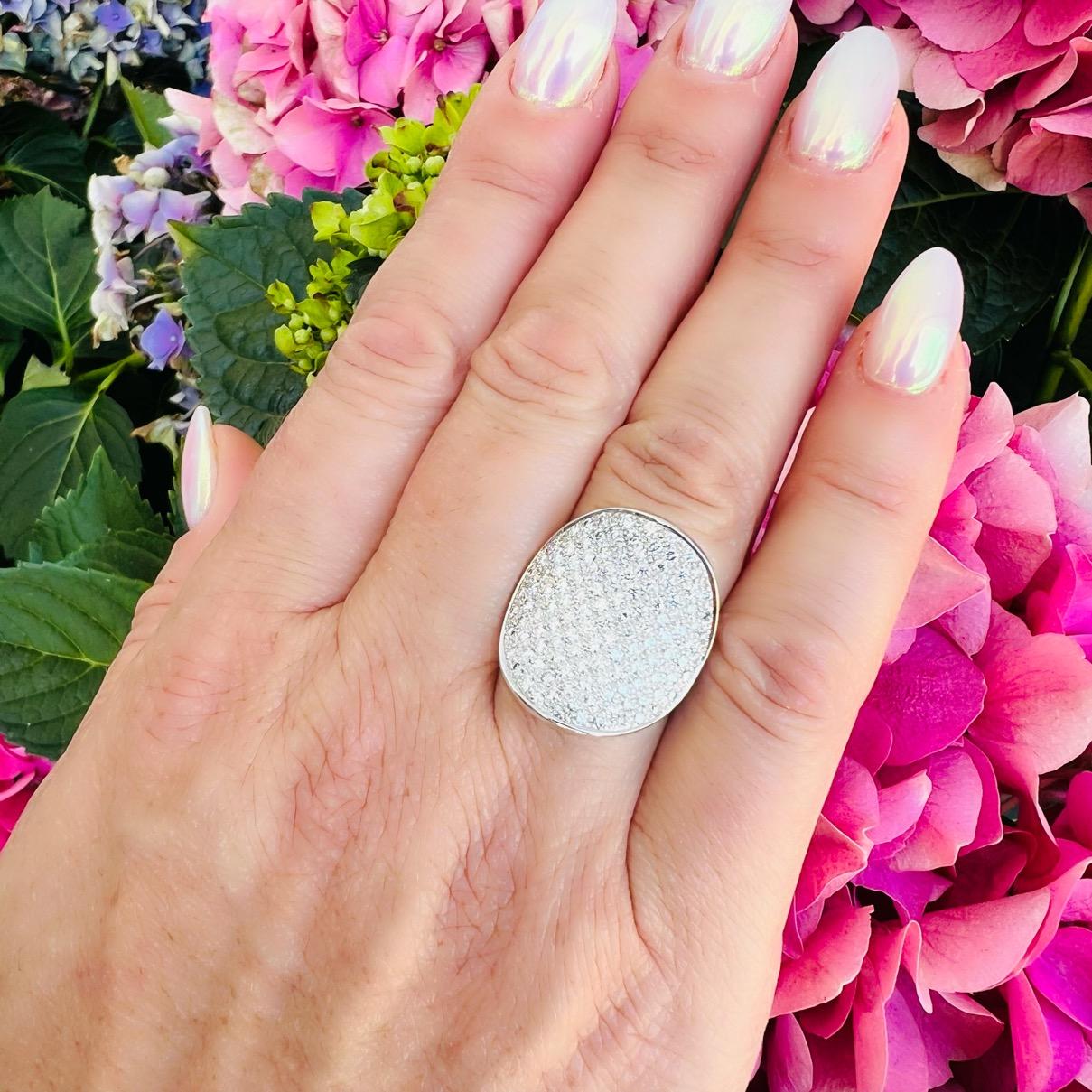 Bold, brilliant and sure to stop traffic, this Kreiger ring is a must have! Designed in 18k white gold, sculpted with a convex oval top pave-set with over 100 round brilliant-cut diamonds weighing 1.60 carats, D/VS quality, it catches the light as