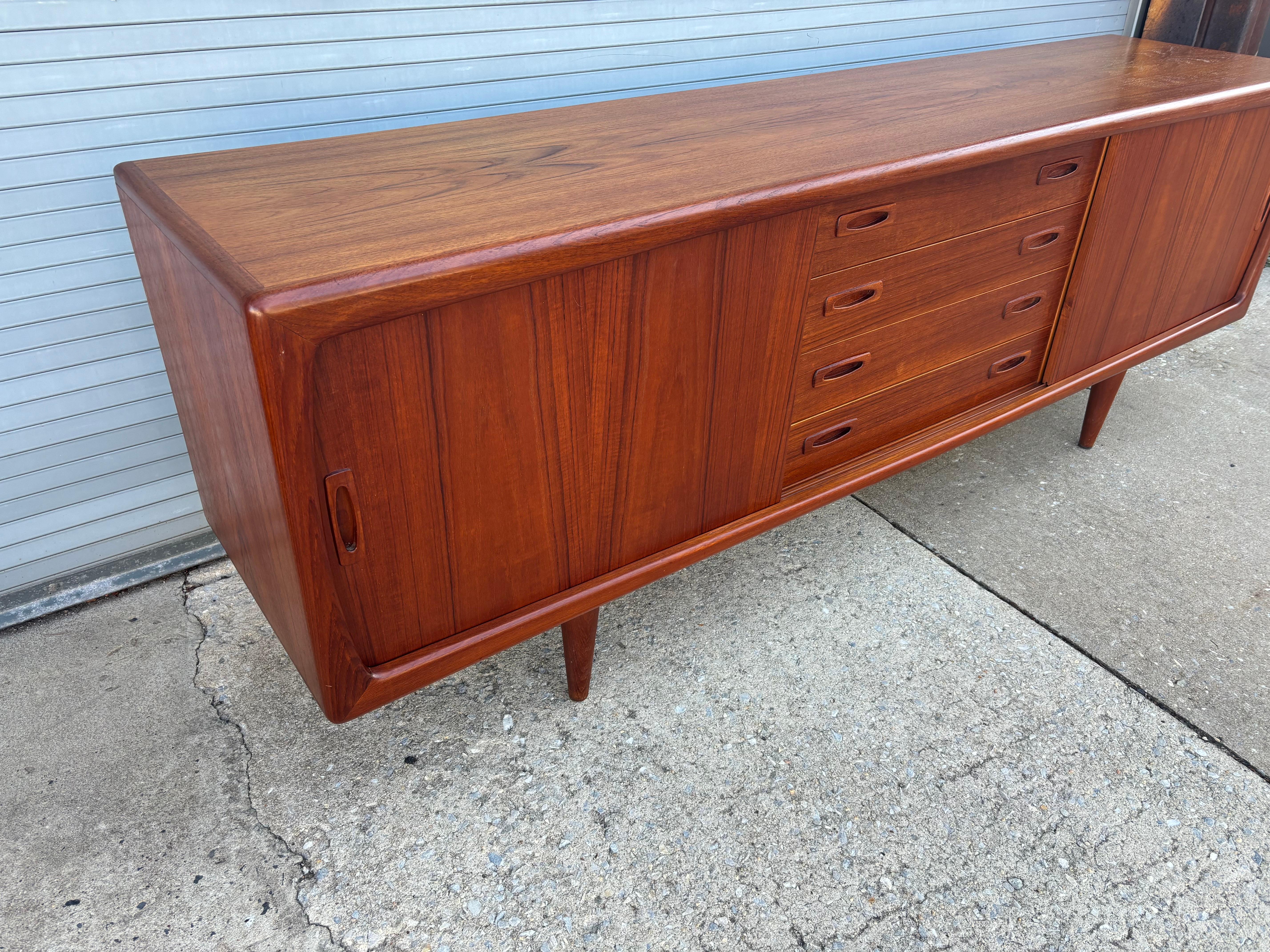 H.P. Hansen Teak Credenza with sliding doors and center drawers.  Beautiful shape with top newly refinished.  86
