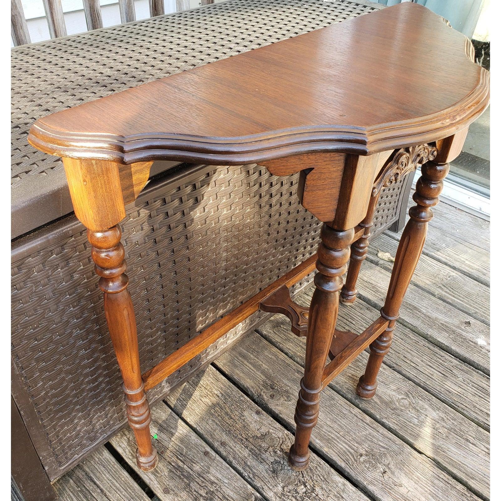 H p Robertson Co. Antique solid walnut console table.
Wood carvings. 
Turned legs.
It measures 30