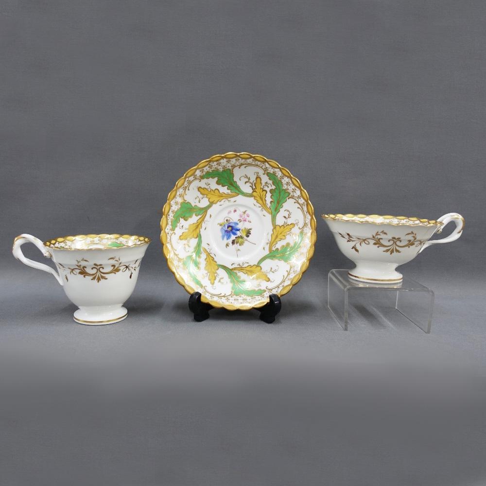 An H & R Daniel English porcelain tea service comprising ten cups, six saucers, milk jug, two handled sucrier, slop bowl and cake plate. The set is made up of 4 true trios which is a coffee cup, a tea cup and a saucer. 2 additional tea cups and