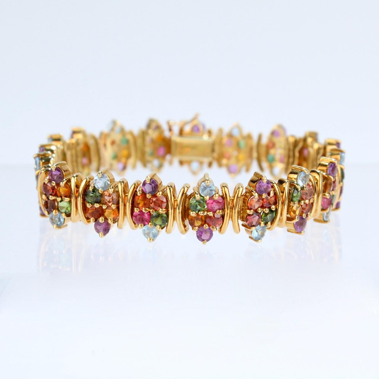 A wonderful H. Stern 18K gold and rainbow gemstone bracelet.

Set with 96 semi-precious stones including amethyst, pink & green tourmaline, aquamarine, and citrine. 

The finest quality and simply lovely on the arm. A wonderful bracelet from one of