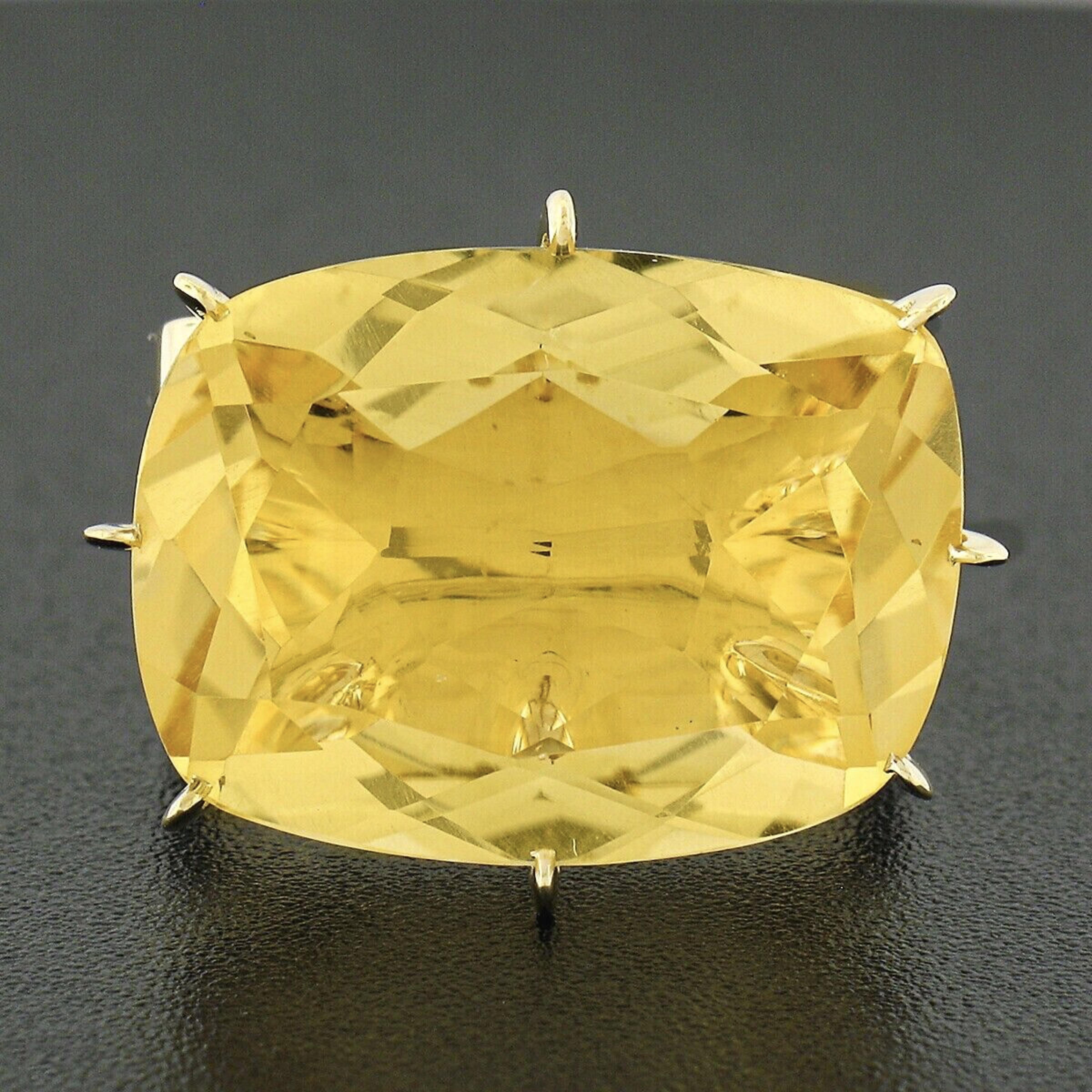 This gorgeous H. Stern cocktail ring was crafted in solid 18k yellow gold and features a large, approximately 12.50 carat, citrine that is neatly set with multiple prongs at its center. The solitaire has a cushion cut and displays a super fine