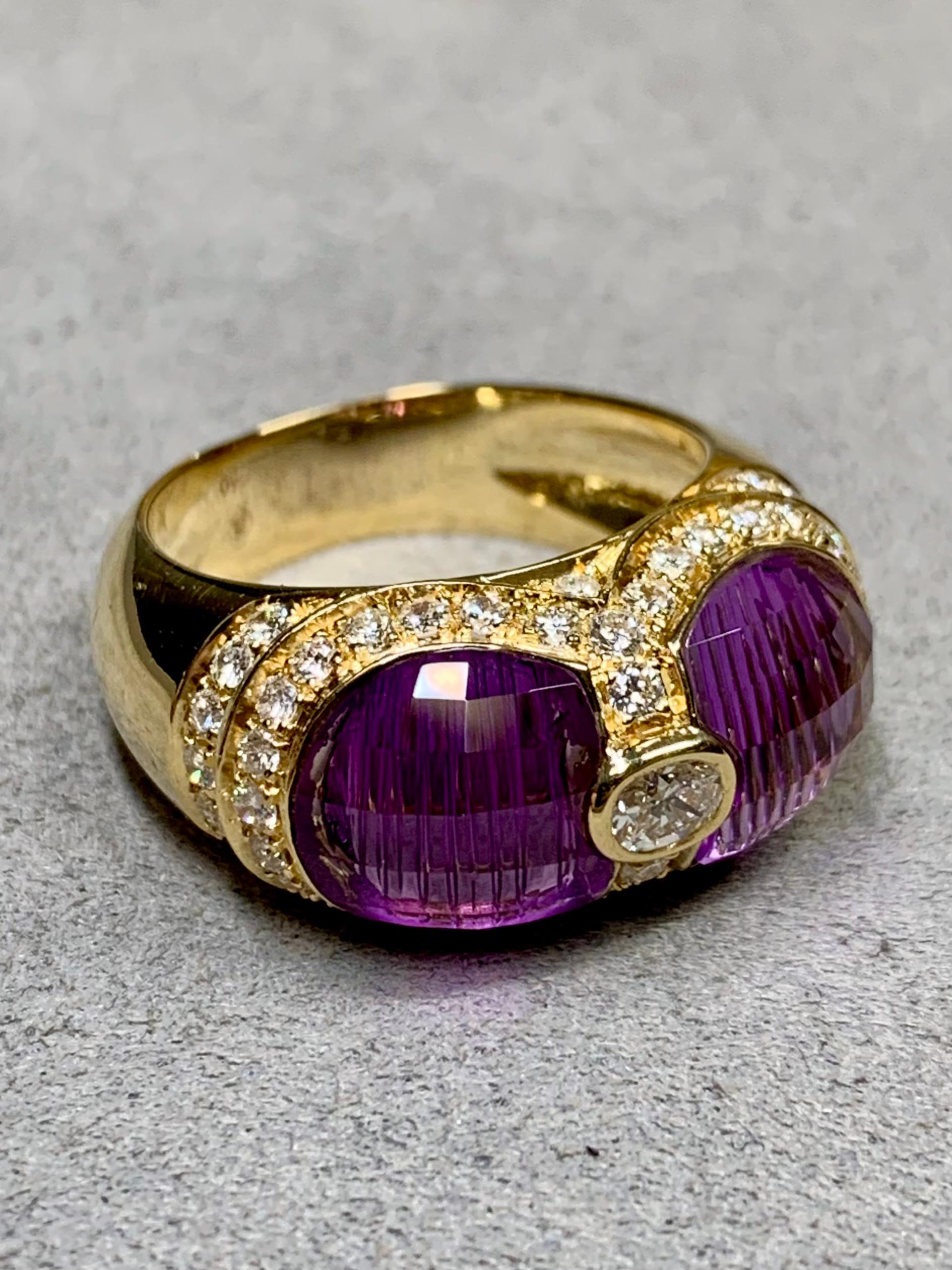 
A unique ring by great Brazilian designer, H. Stern. Done in 18K yellow gold, this ring has been set with two side-by-side fantasy cut natural amethysts and surrounded by approximately 1.10ctw in G-H color Vs1-2 clarity round