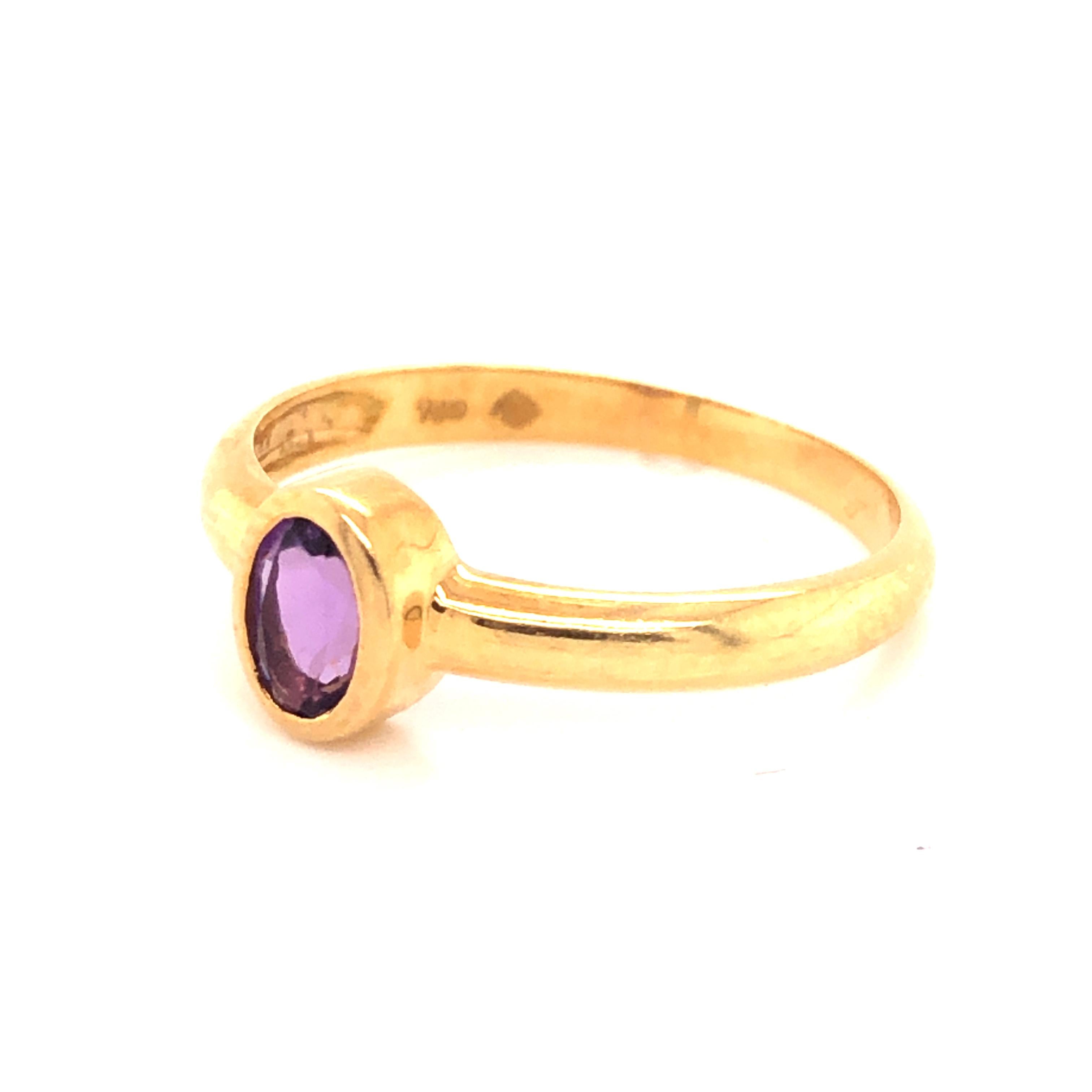 Beautiful ring from famed designer H. Stern crafted in 18k yellow gold. This beautiful ring has one oval cut Amethyst gemstone bezel set with a vivid purple color. The ring is in excellent condition and has recently been polished by our in house