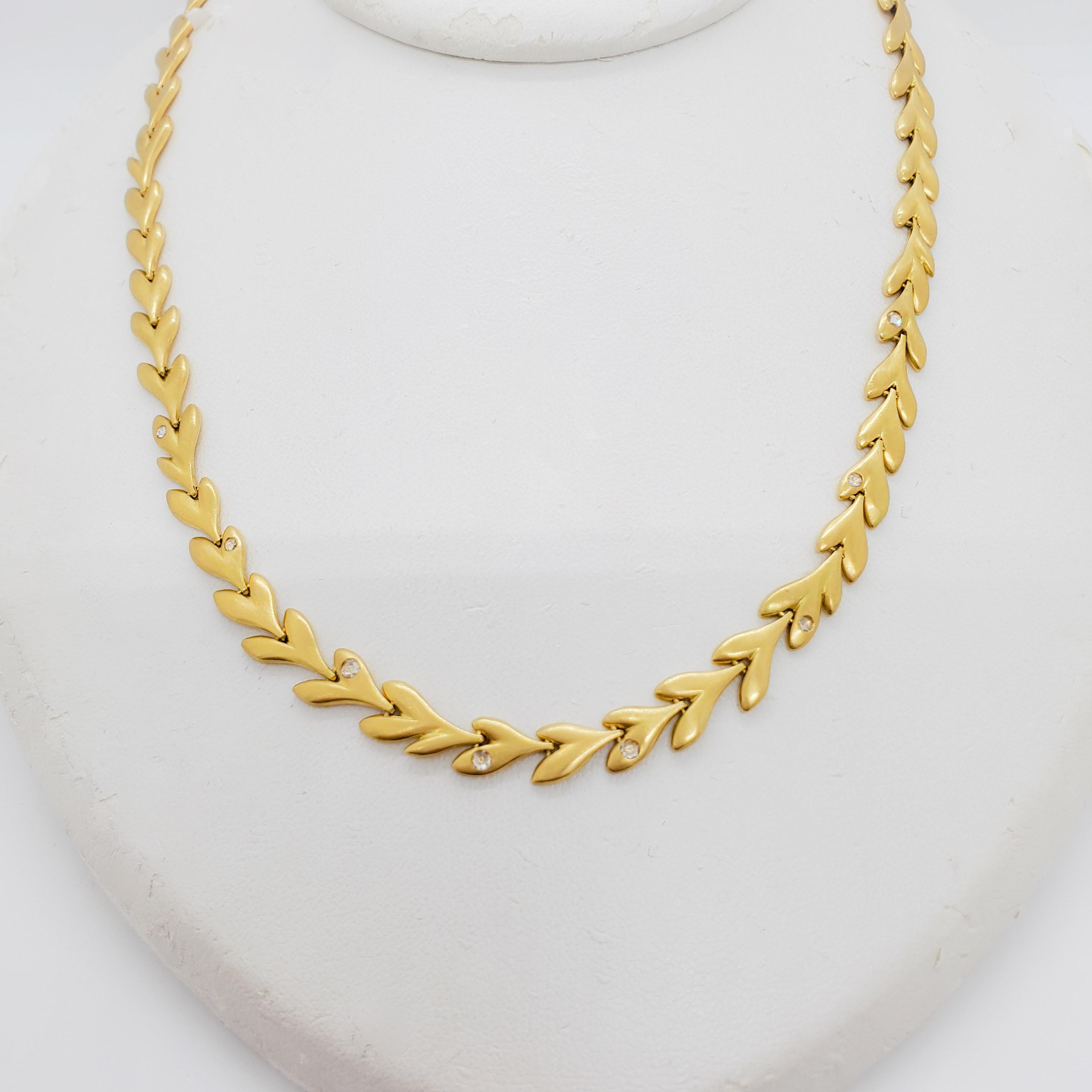 Beautiful H. Stern necklace with gold hearts and some small diamond rounds throughout.  Handmade in 18k yellow gold.