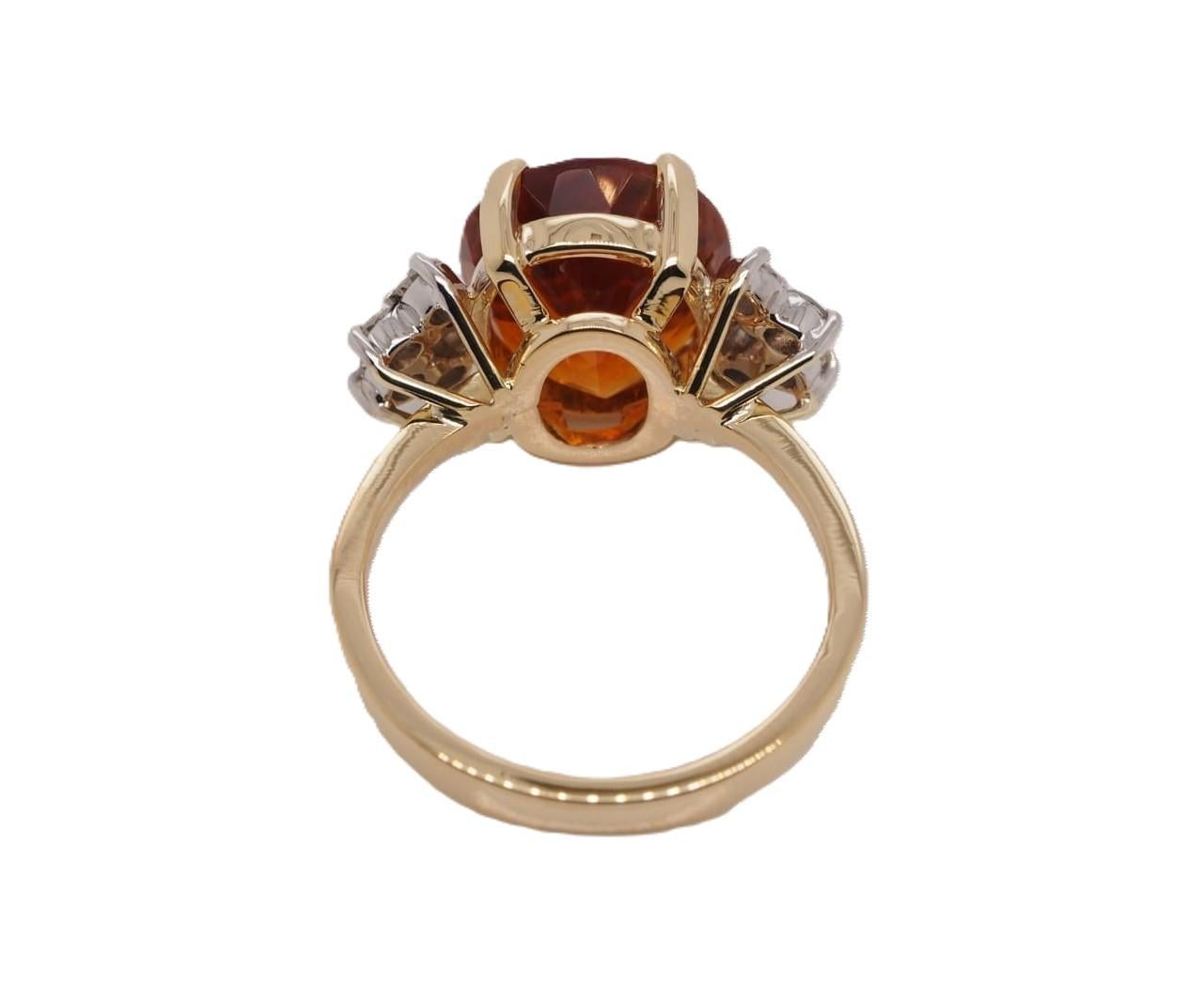 This stunning H. Stern ring features an oval citrine stone measuring 10.6 x 12.8 mm in a prong setting. The citrine is accented with 10 round diamonds totaling 0.35 carats. The band is made of 18k yellow gold and is 2 mm wide. The ring is size 7 and