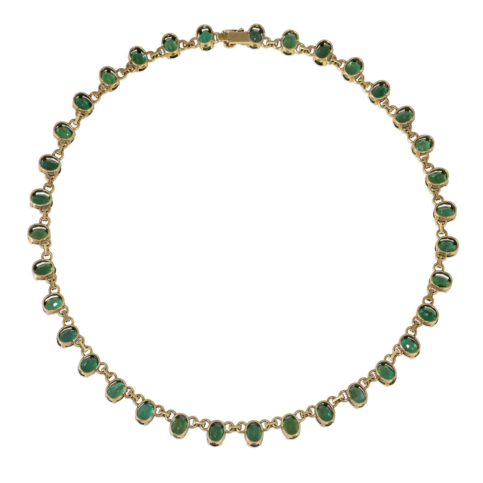 A mid-century 1950s gold and tourmaline rivière style necklace comprised of oval-cut green tourmalines with ribbed link spacers, completed by a tongue and box closure with a safety mechanism, in 18k.  H Stern.

* Includes letter of authenticity
*