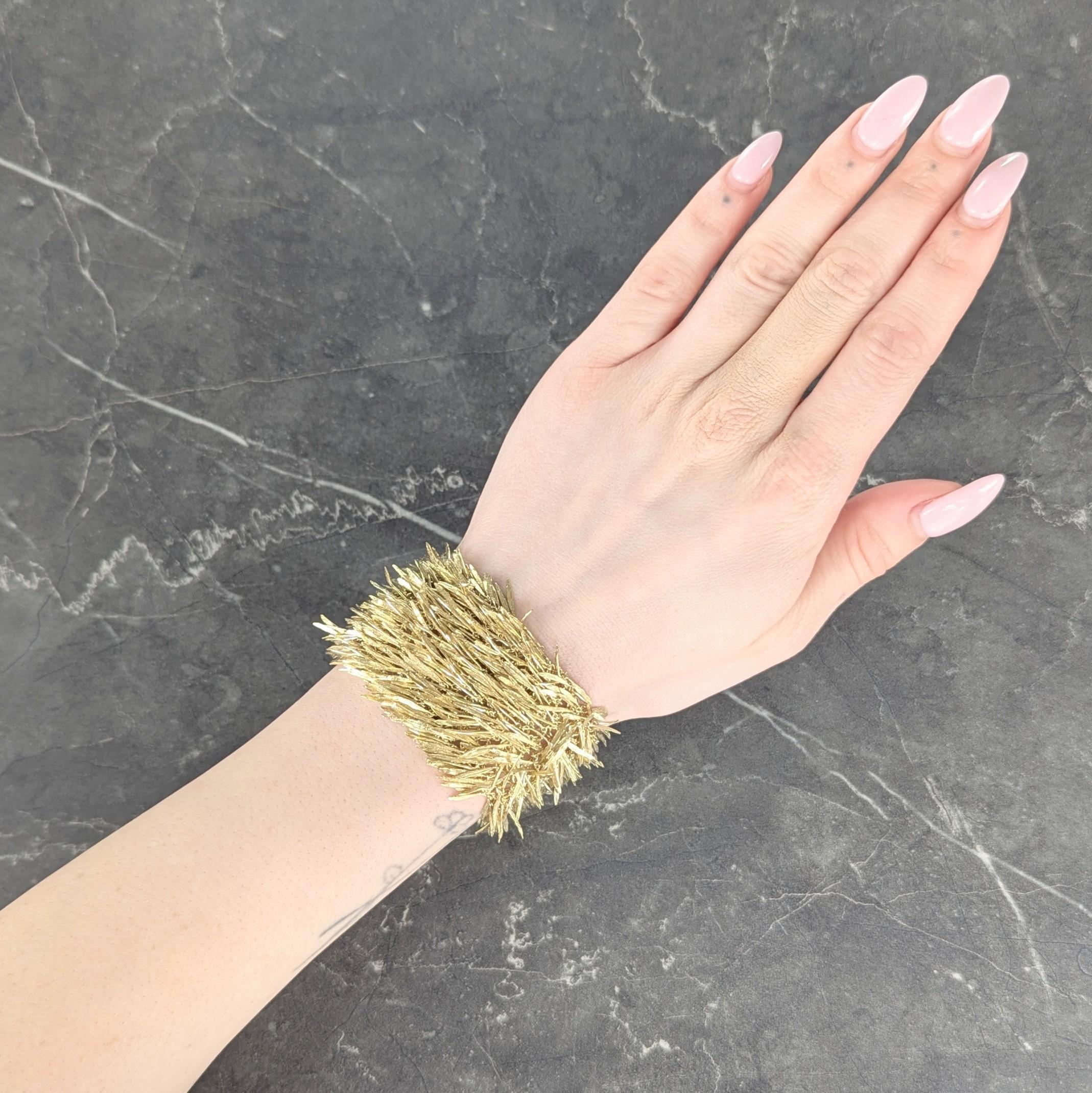 Designed as wide meshed chainmail links with playful fringe
Comprised of articulating feather motif charms throughout
Each is engraved with feather details
Completed by slide clasp closure
With a hinged figure eight safety
Stamped for 18 karat