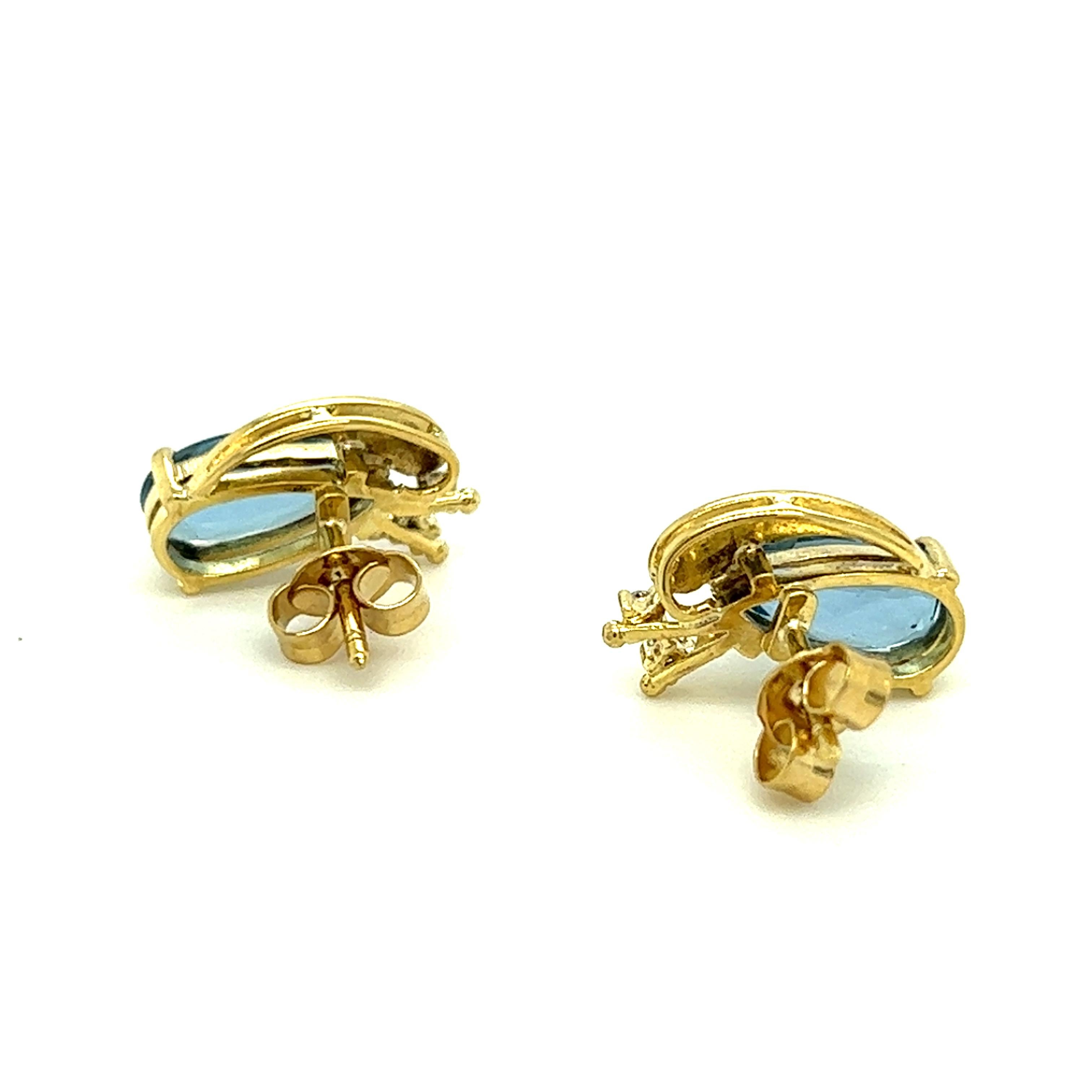 One pair of 18-karat yellow gold earrings by H. Stern, each set with one 15x12mm pear-shaped aquamarine stone and two round brilliant cut diamonds, approximately 0.06-carat total weight with matching H/I color and VS clarity.  The earrings are