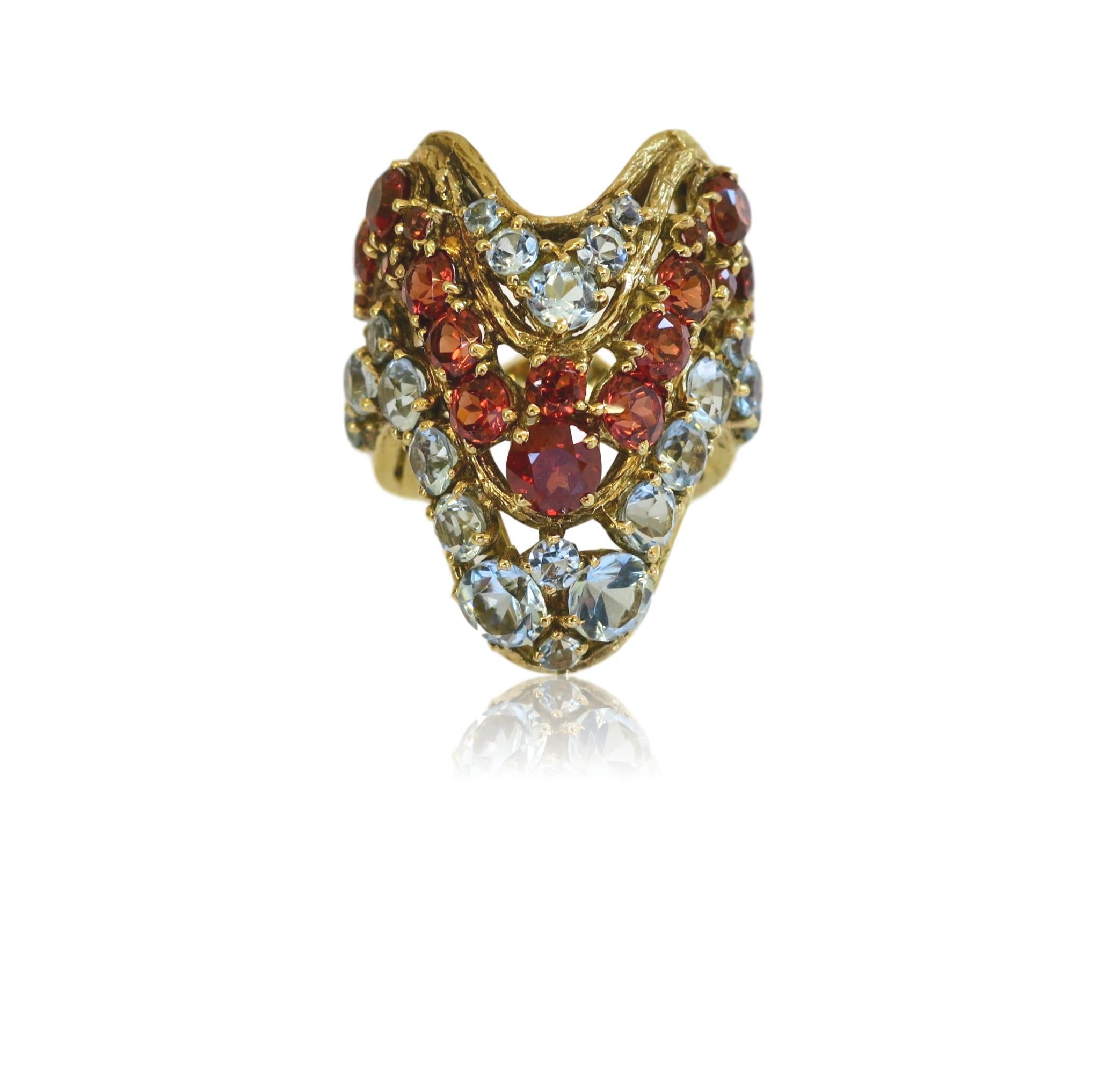 A Multi-color Gemstone cocktail ring by H.Stern. The chevron patterned textured 18k ring with alternating rows of round icy aquamarines and rich orange-brown hessonite garnets. 
Inspired by the  pendulum swing in fashion .. Gucci , Prada, etc. we