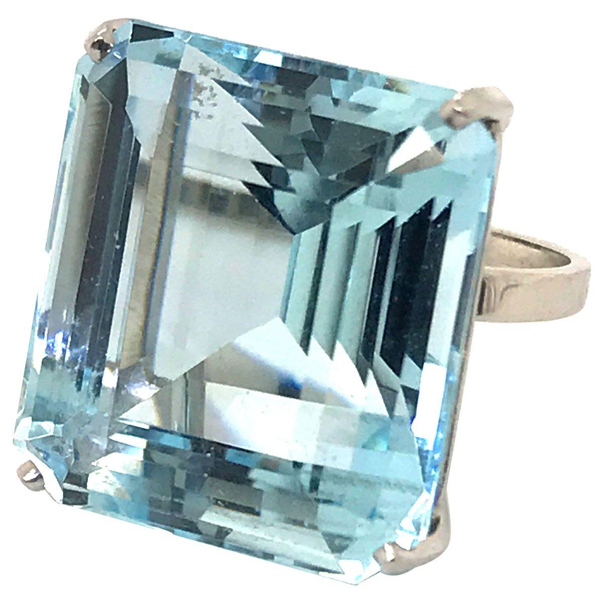 Wow, what a knockout ring! It certainly won't go unnoticed, with its magnificent emerald cut aquamarine that sits front and centre. Measuring 22.03 x 19.73 x 14.40mm it is approximately 30+ carats. The soft blue green tone of the aquamarine is very