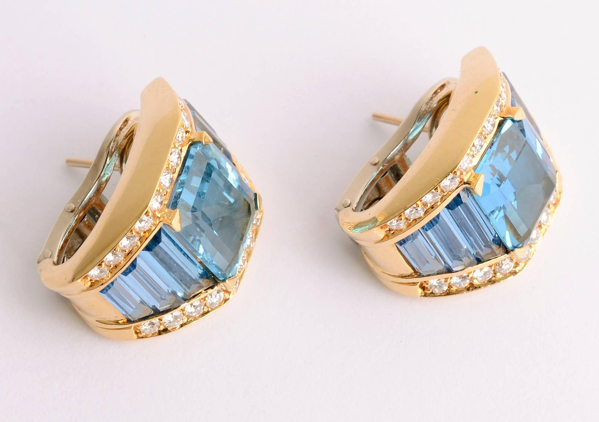 Beautifully colored blue topaz earrings with diamonds by H. Stern. The central blue topaz is approximately 4 carats with three graduated smaller ones top and bottom. Backs are clips and posts.