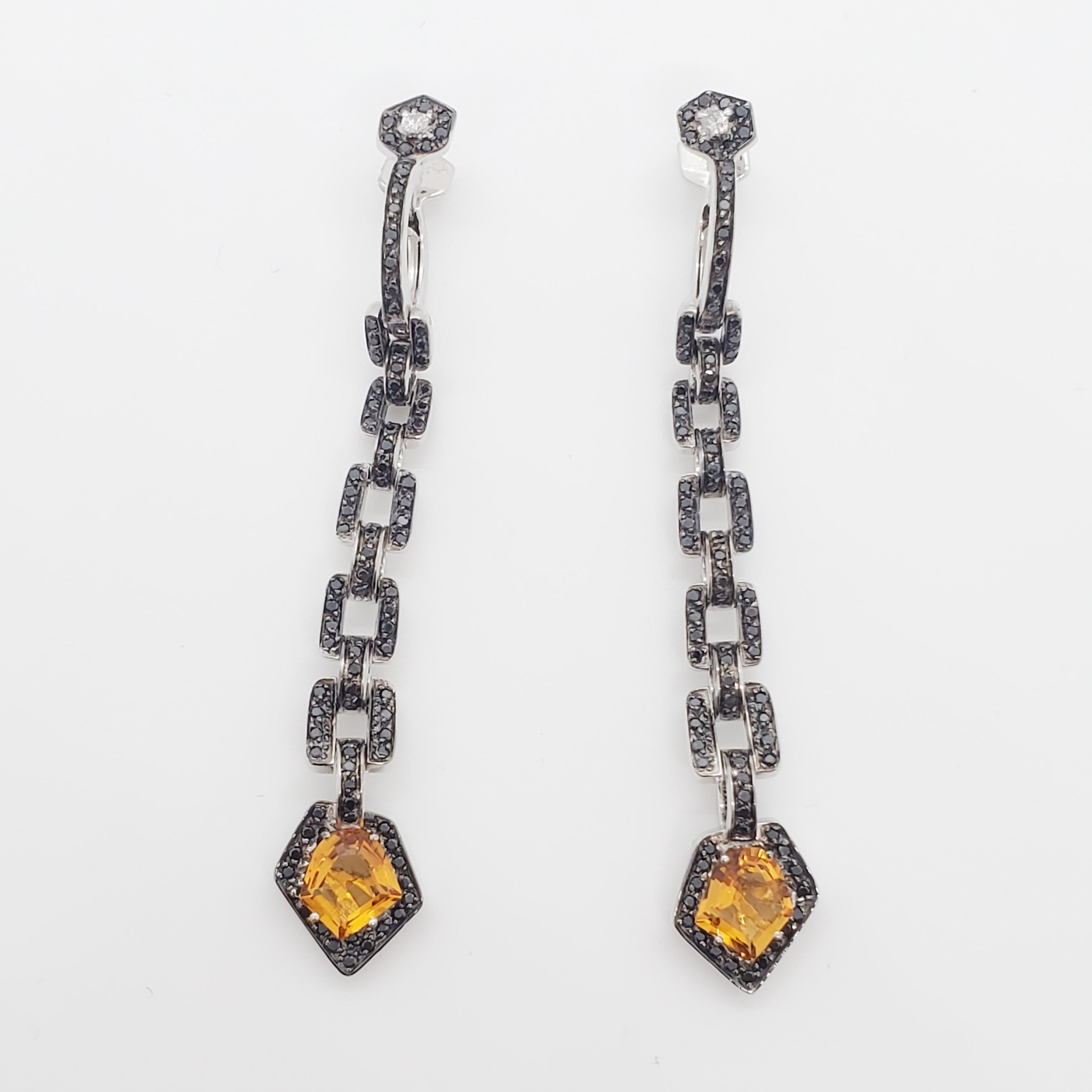 Stunning estate H. Stern earrings featuring 2.44 ct. citrines in a novelty cut with 5.50 ct. of black diamond rounds.  