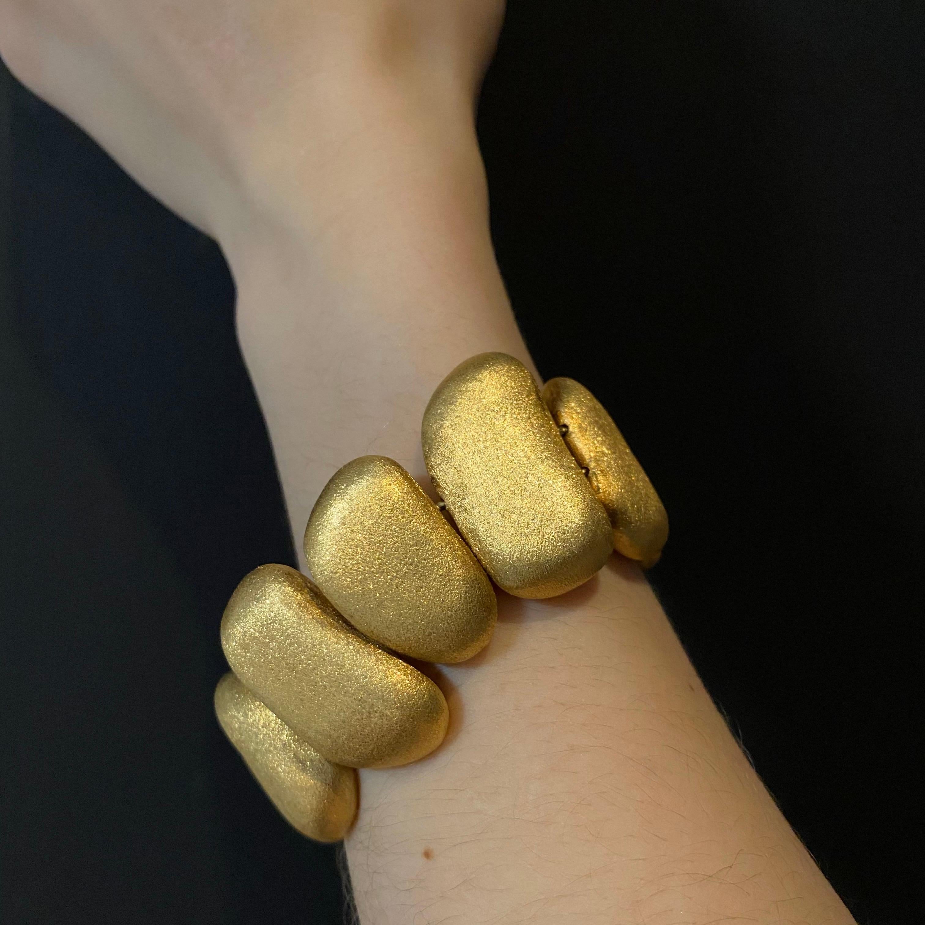 H. Stern Contemporary 10 Textured Golden Stones Bracelet in 18 Karat Yellow Gold, Brazil, Signed, 2010s. Designed as a sequence of ten unevenly shaped textured gold pebbles, the stones of varying sizes have an aventurescence-like effect to their
