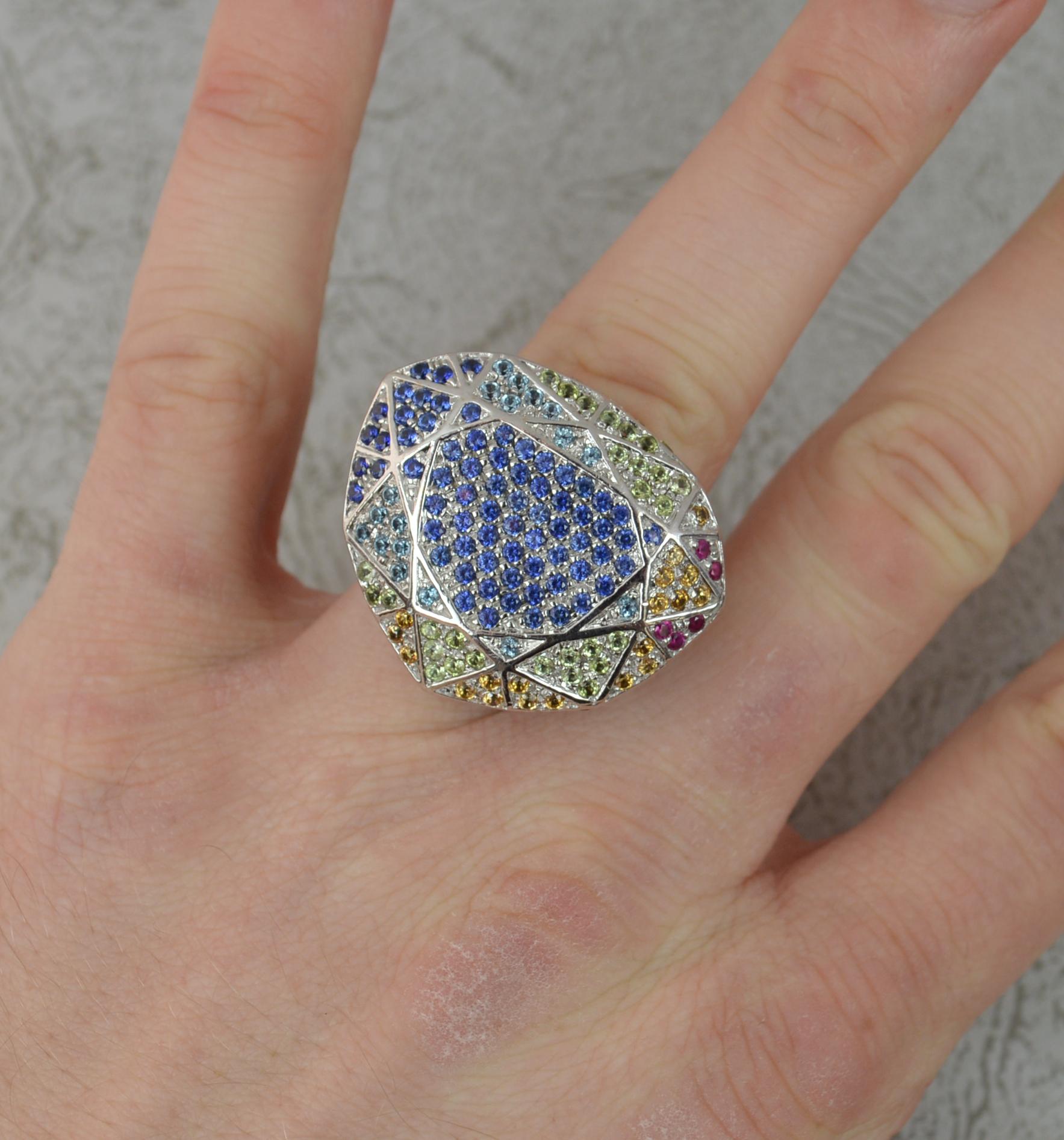 A stunning designer ring by H Stern and Diane Von Furstenberg.
Heavy, large and solid 18 carat white gold example.
Known as the 'Power' ring.
Multi faceted shaped head. Set with an array of natural, round brilliant cut sapphires of all colours.
30mm