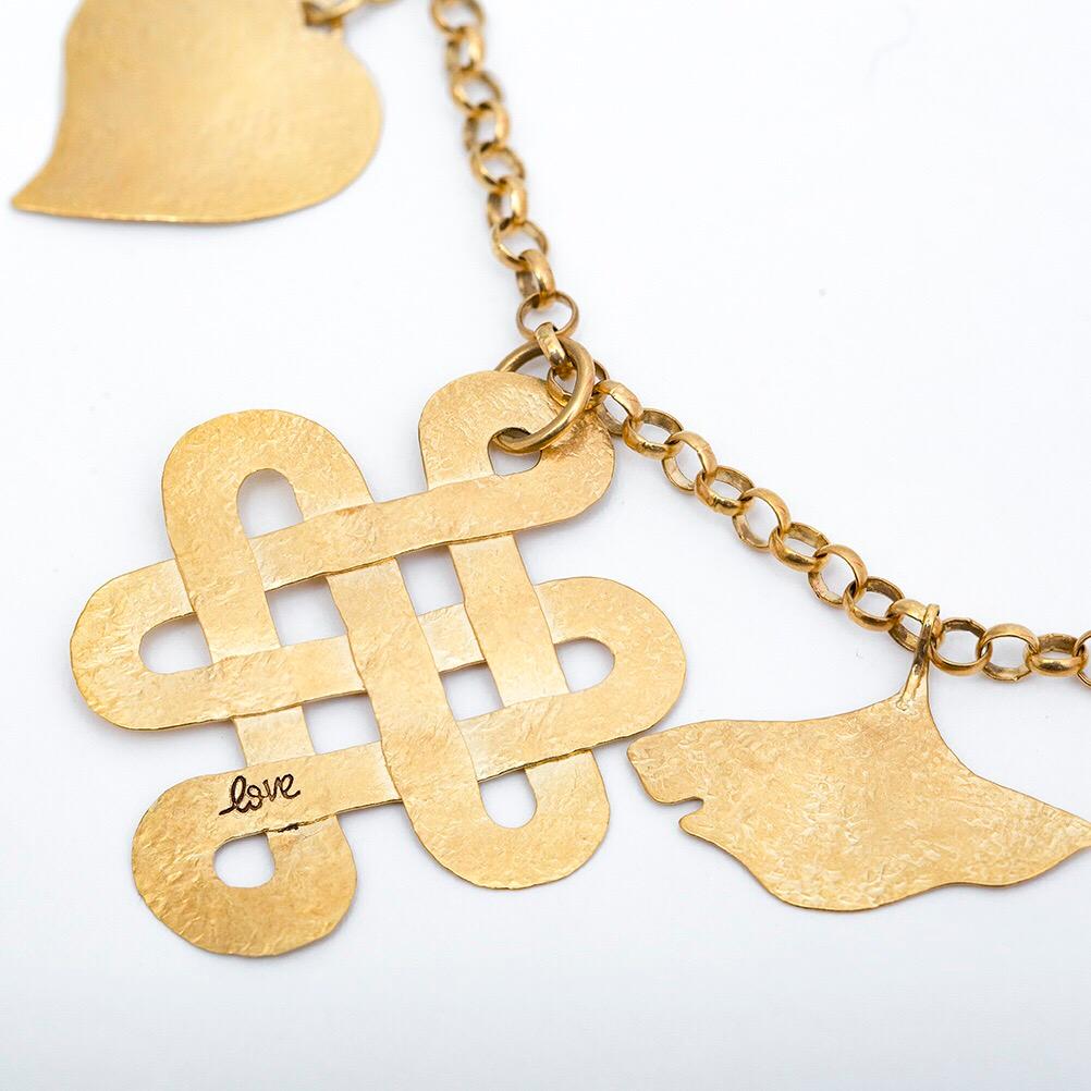 Diane Von Furstenberg for H. Stern creates the Talisman Collection in 2009. The Bracelet features a Heart which symbolizes love and strength, a Tibetian love knot for eternal love, and the gingko Leaf as a symbol of health and longevity. In 18 karat
