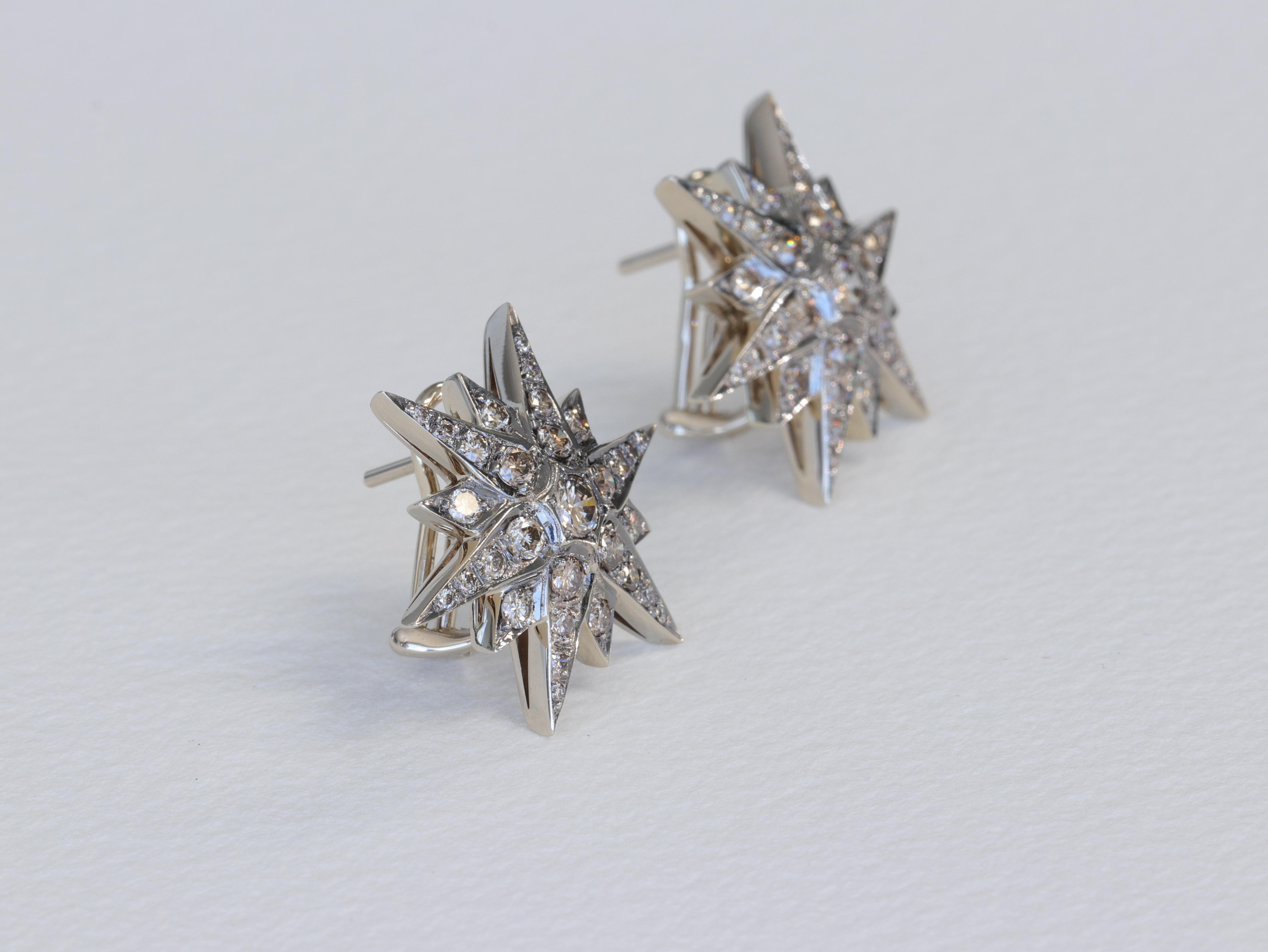 These H Stern earrings of the Genesis collection feature cognac colored round brilliant cut diamonds set in a star or sun ray pattern in 18 karat 