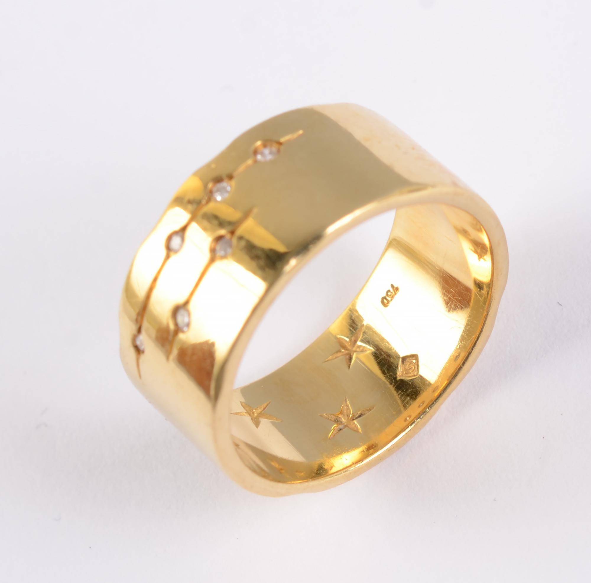 Wide band gold ring with diamonds by Brazilian jeweler, H. Stern. The ring is from their Code collection in which the six small, irregularly placed diamonds are meant to create an enigmatic pattern. It is a reference to secret codes that can only be
