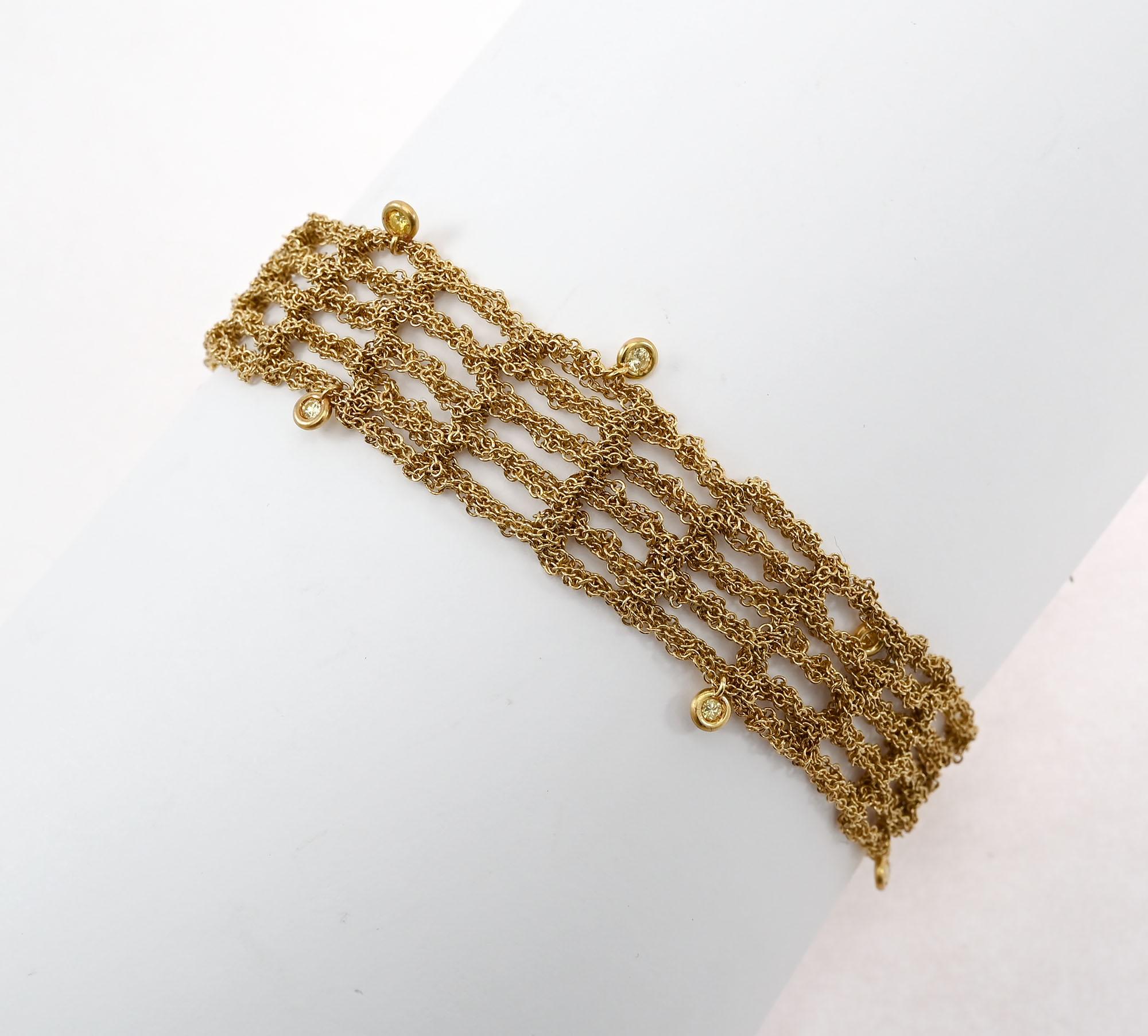 Delicate mesh chain bracelet by H. Stern. The bracelet has 5 rows of tiny interwoven circles creating a delicate mesh effect. Nine small round diamonds add a hint of bling. The bracelet is 9/16