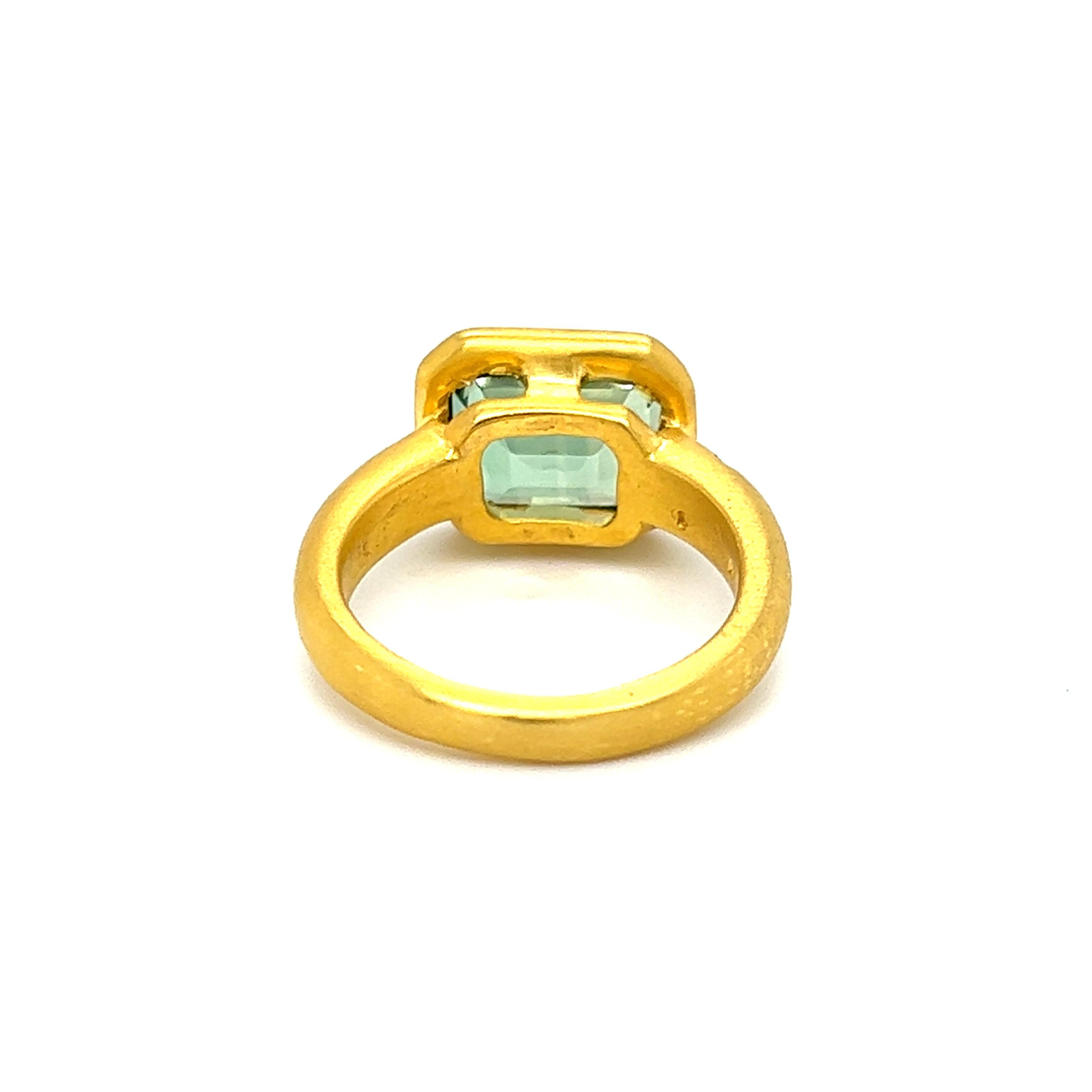 One 18-karat yellow gold brushed finished ring, designed by H. Stern, set with one 11x9mm emerald cut light green tourmaline and one round brilliant cut diamond, approximately 0.03 carat total, with H/I color and VS1 clarity.  The ring is stamped