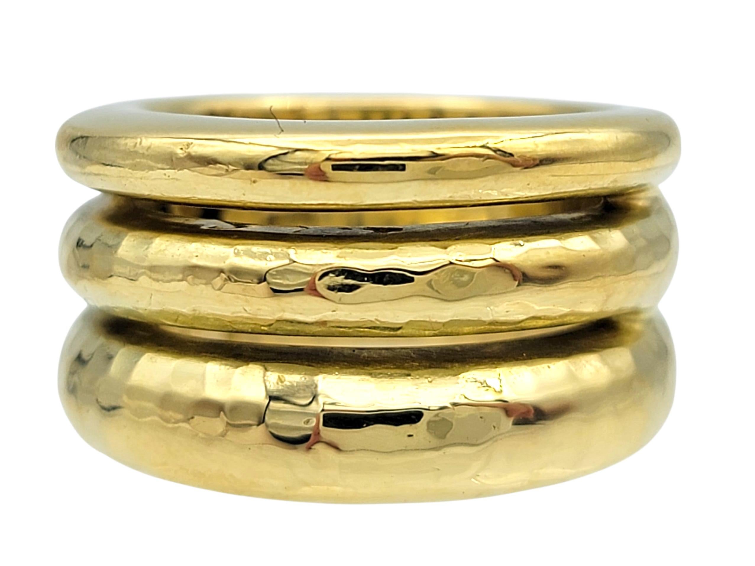 This bold and elegant H. Stern Louise ring is crafted in luxurious 18 karat yellow gold. Designed with a distinctive hammered finish, it features three wide rows that create a striking, textured look with a timeless appeal.

The wide band design