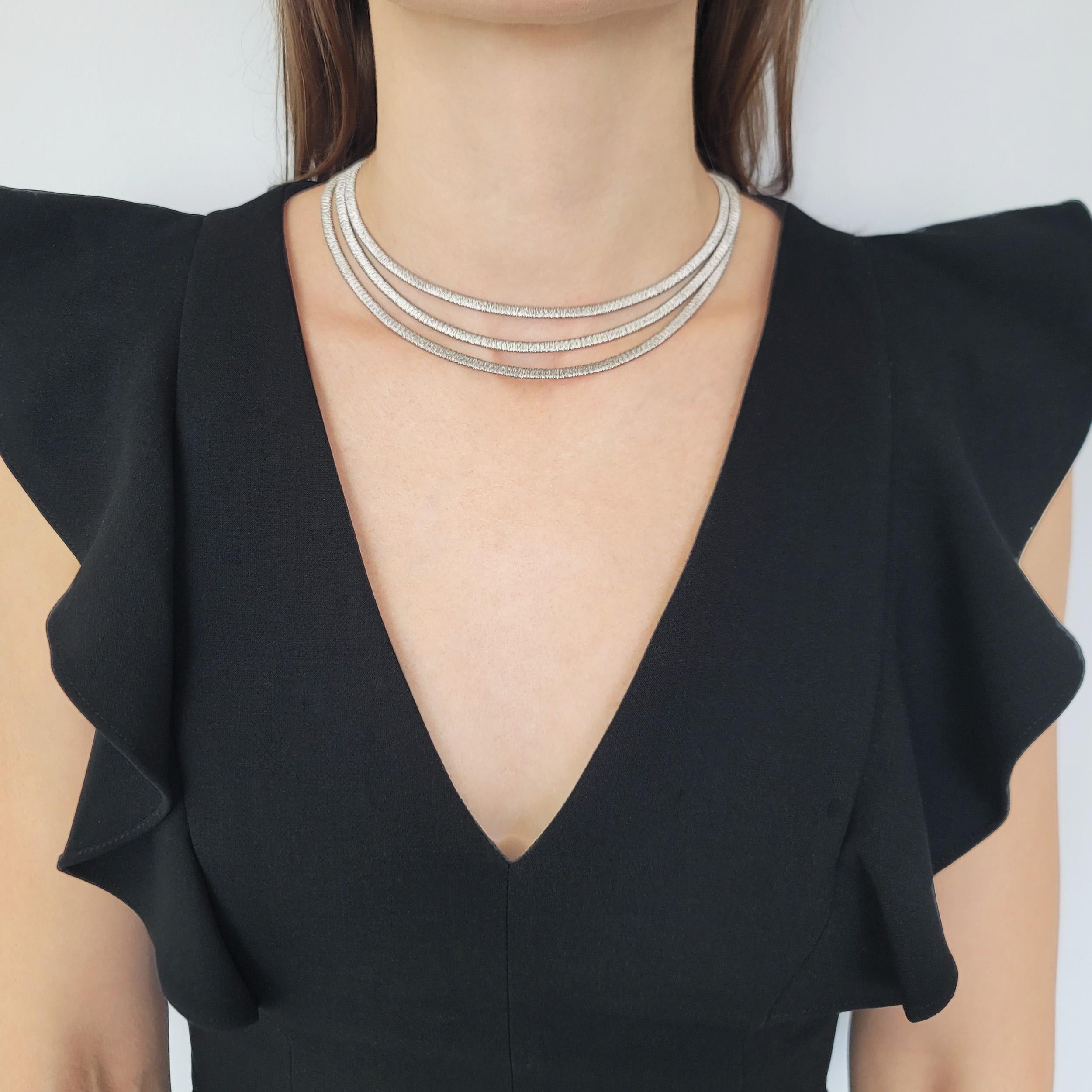 H. Stern Multi Row Necklace In 18k White Gold. The necklace
features 3 rows of flat omega style mIcro wire wrapped chain
graduating in lengths. Equipped with brushed finish
diamond accented box clasp with fold over safety closure.
There is a total