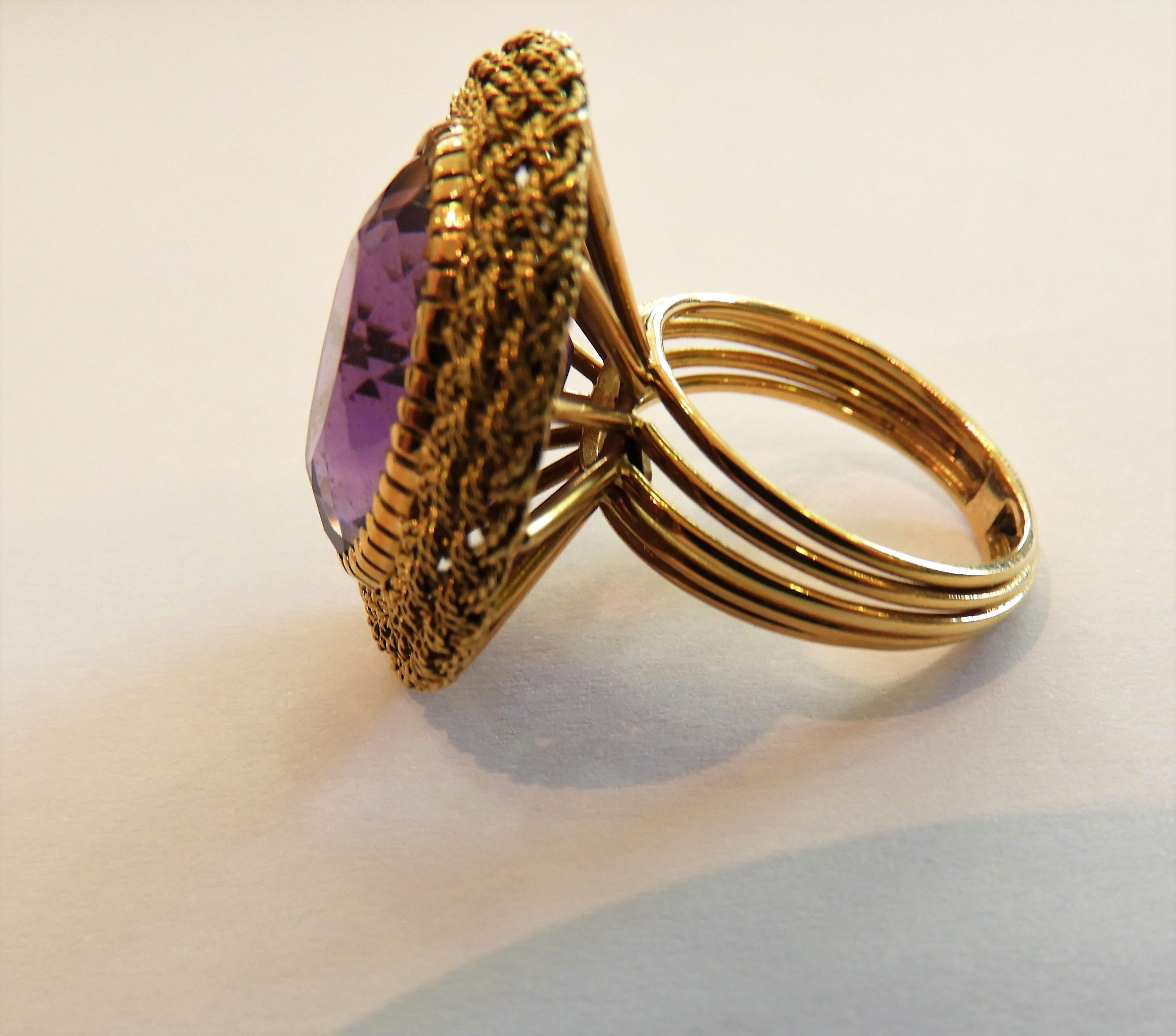 This H. Stern Diamond & Amethyst Cocktail Ring Crafted in solid 18K  Yellow Gold. 
The center is adorned by an oval shape, cabochon cut, prong-set, Amethyst weighing 11,34 carats.
Total weight 14gr and Ring Size around 71/2 Ring can be adapted