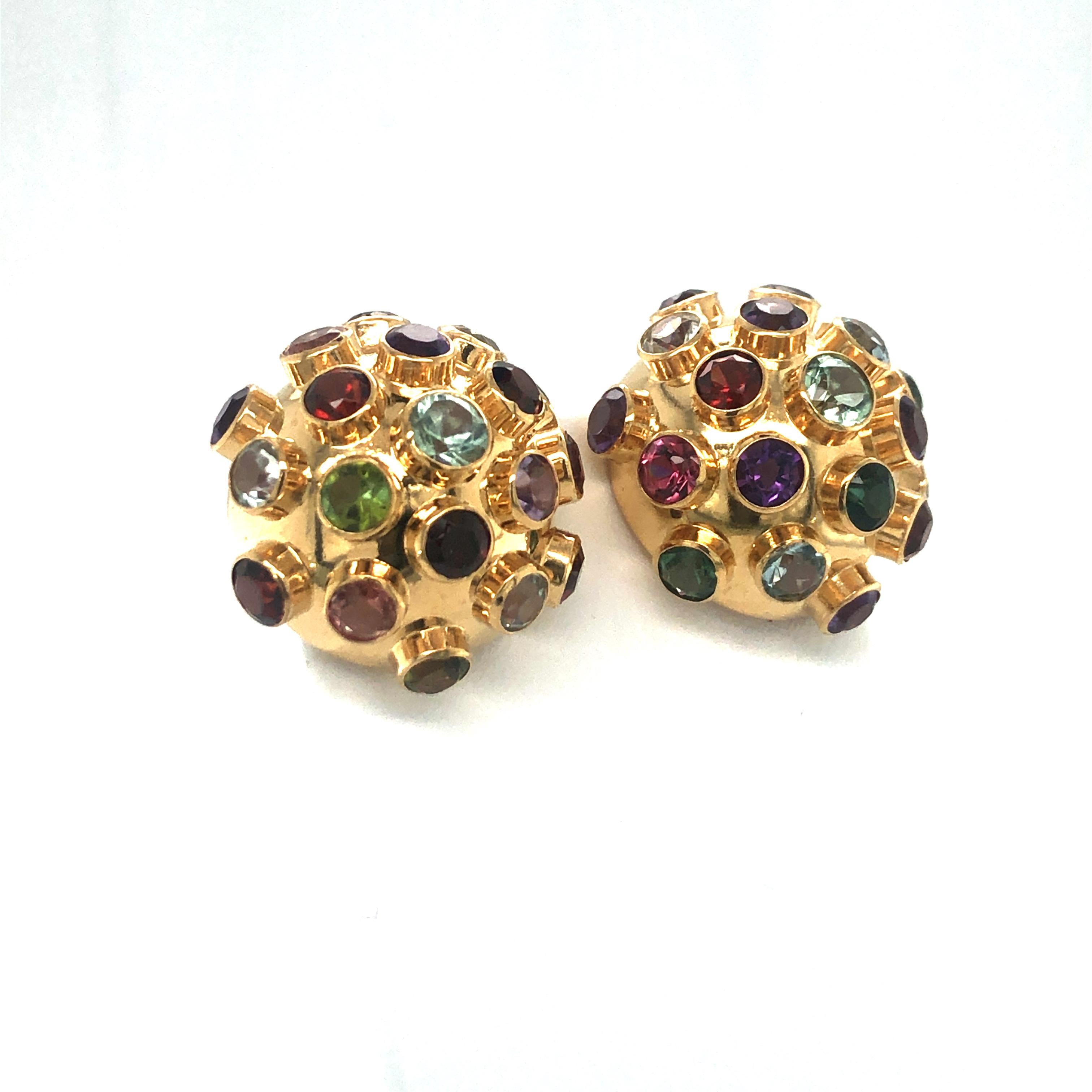 These playful sputnik style earclips were designed by famous Brazilian jeweller H. Stern in the 1950s. They are crafted in 18 karat yellow gold and set with a total of 38 different brilliant-cut coloured gemstones (tourmaline, aquamarine, garnet,
