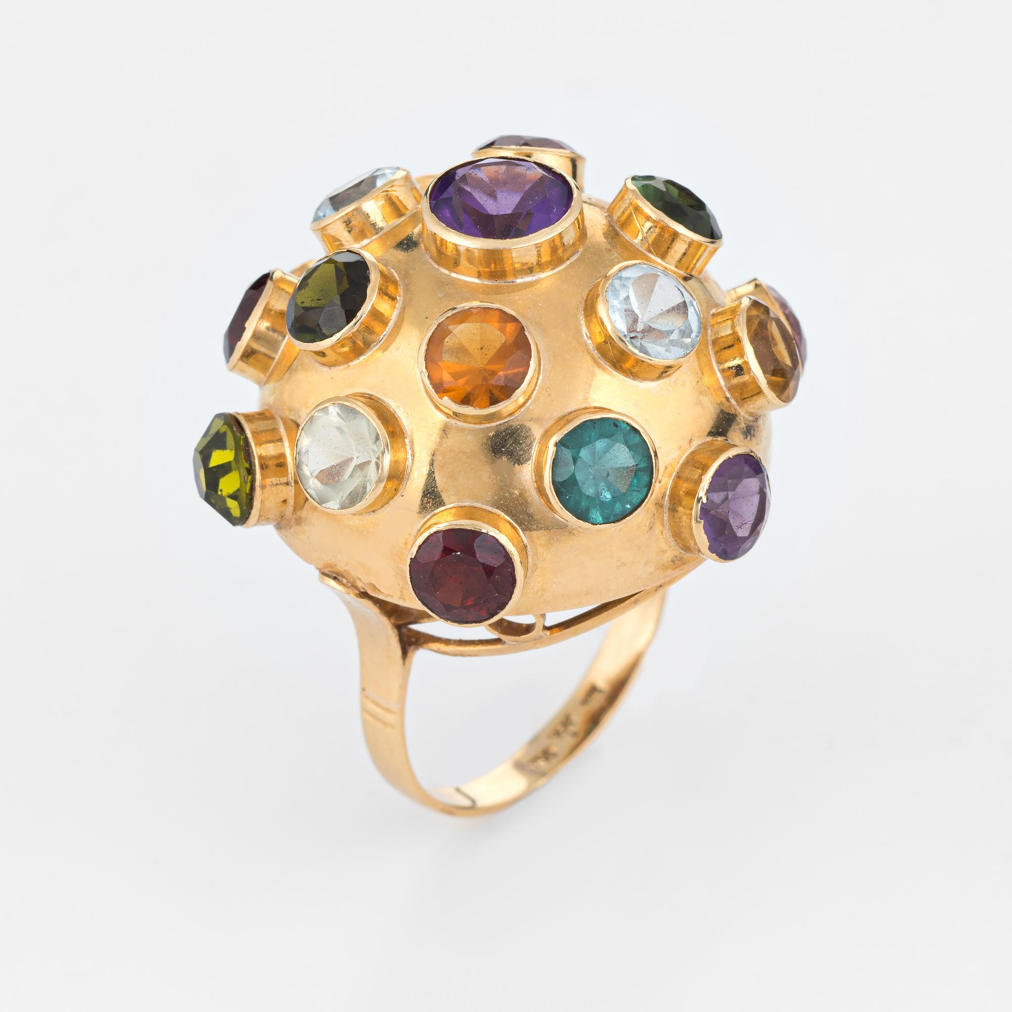 Ornate H Stern sputnik domed gemstone cocktail ring (circa 1950s to 1960s), crafted in 18 karat yellow gold. 

Semi-precious gemstones (blue topaz, amethyst, aquamarine, pink & green tourmaline, citrine, peridot and garnet) total an estimated 5.50