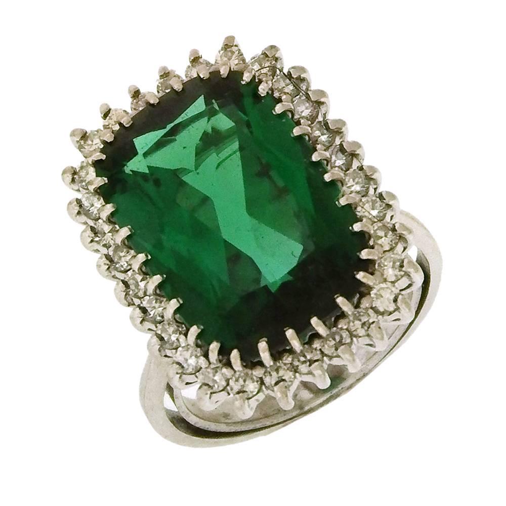 Gem blue-green tourmaline and diamond ring and earring set from the masters of South American gems, H.Stern. The beautiful faceted scissor-cut (rectangular step-cut) gems-- 9.30 carats the ring and 11.20 carats earrings -- are set in 18K white gold