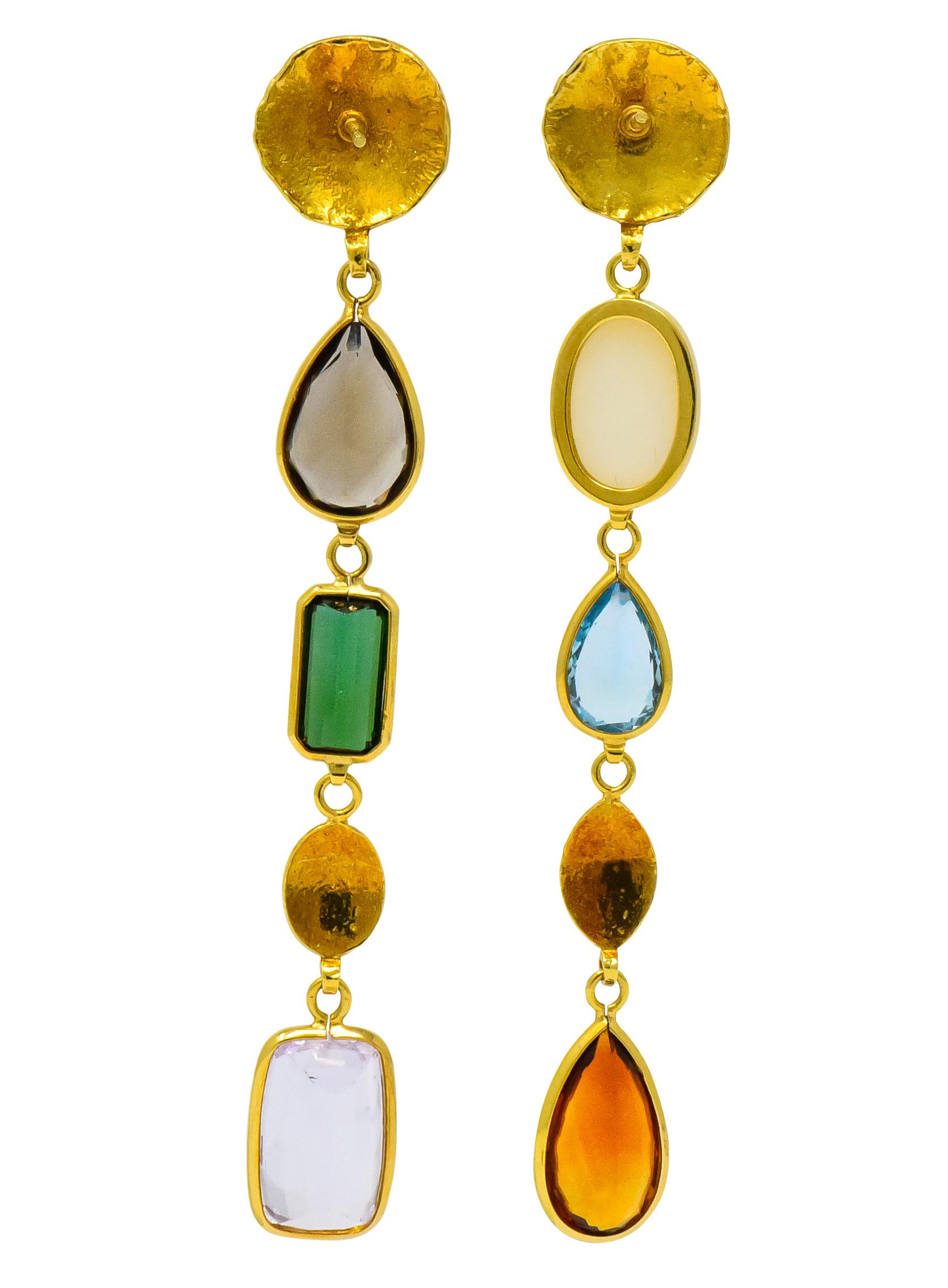 Each with textured gold disc surmounts, connected to bezel set drops comprised of various shaped and colored gemstones

One with oval cabochon opal, pear cut blue topaz, and pear cut citrine 

The other with pear cut smokey topaz, rectangular cut