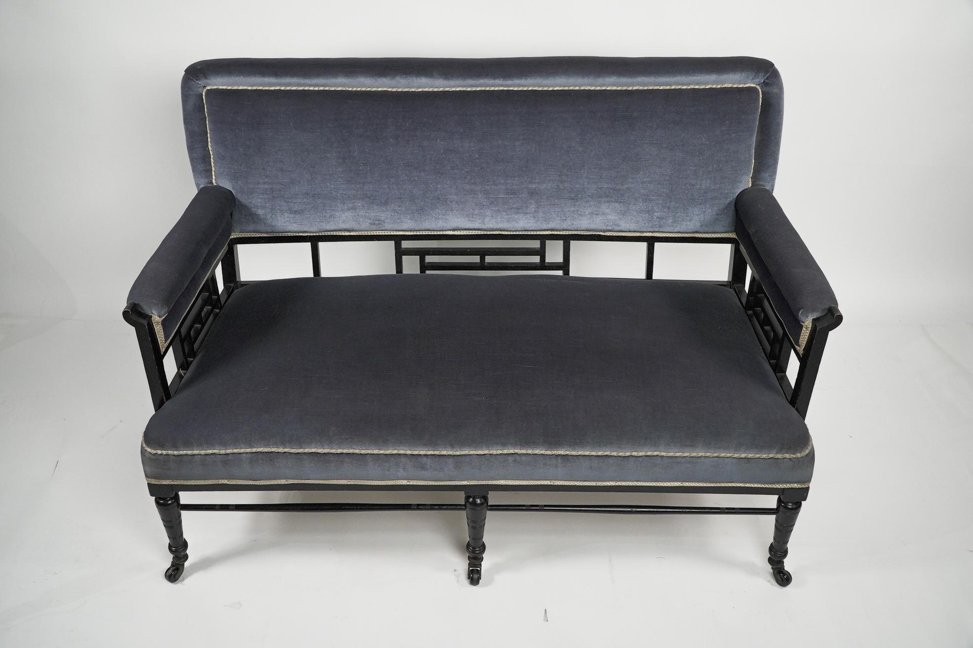 Anglo-Japanese H W Batley. Anglo Japanese settee with fretwork below the backrest & to the arms For Sale