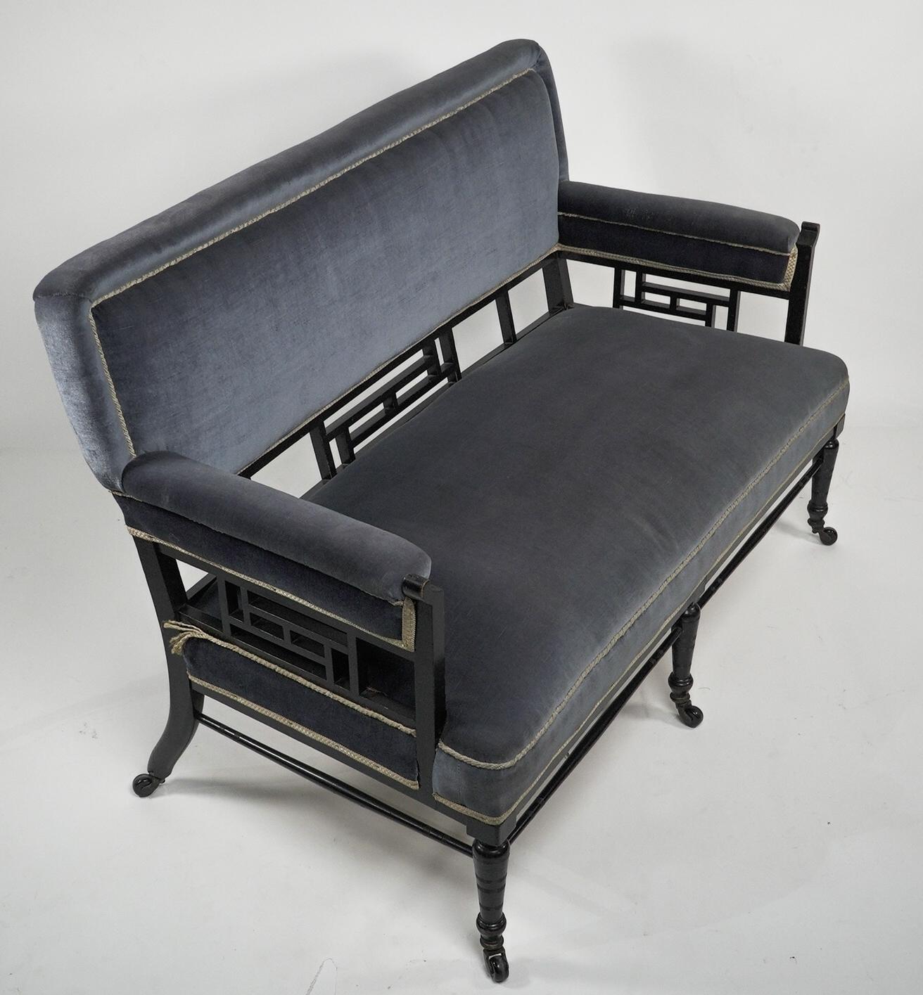 English H W Batley. Anglo Japanese settee with fretwork below the backrest & to the arms For Sale