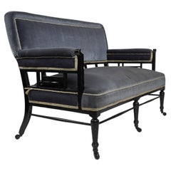 H W Batley. Anglo Japanese settee with fretwork below the backrest & to the arms