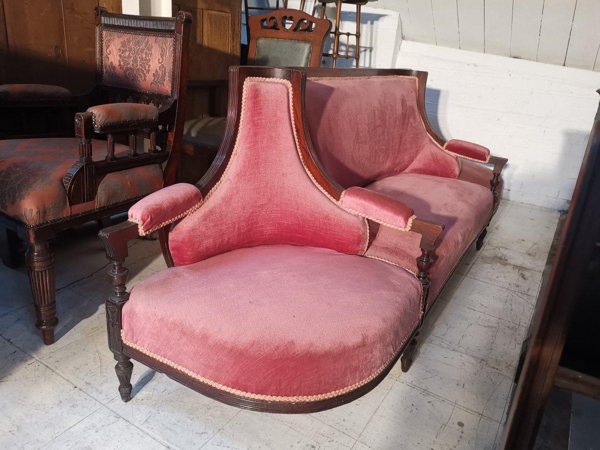 Henry William Batley, attributed (probably) for Collinson and Lock, an unusual Aesthetic Movement rosewood 'Courting Sofa' with D shaped armchairs to each end for the chaperones and a loving duet seat to the middle. The circular carved and tram line
