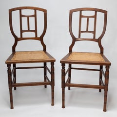 H W Batley attr. Jas Shoolbred Pair of Aesthetic Movement cane seat beech chairs
