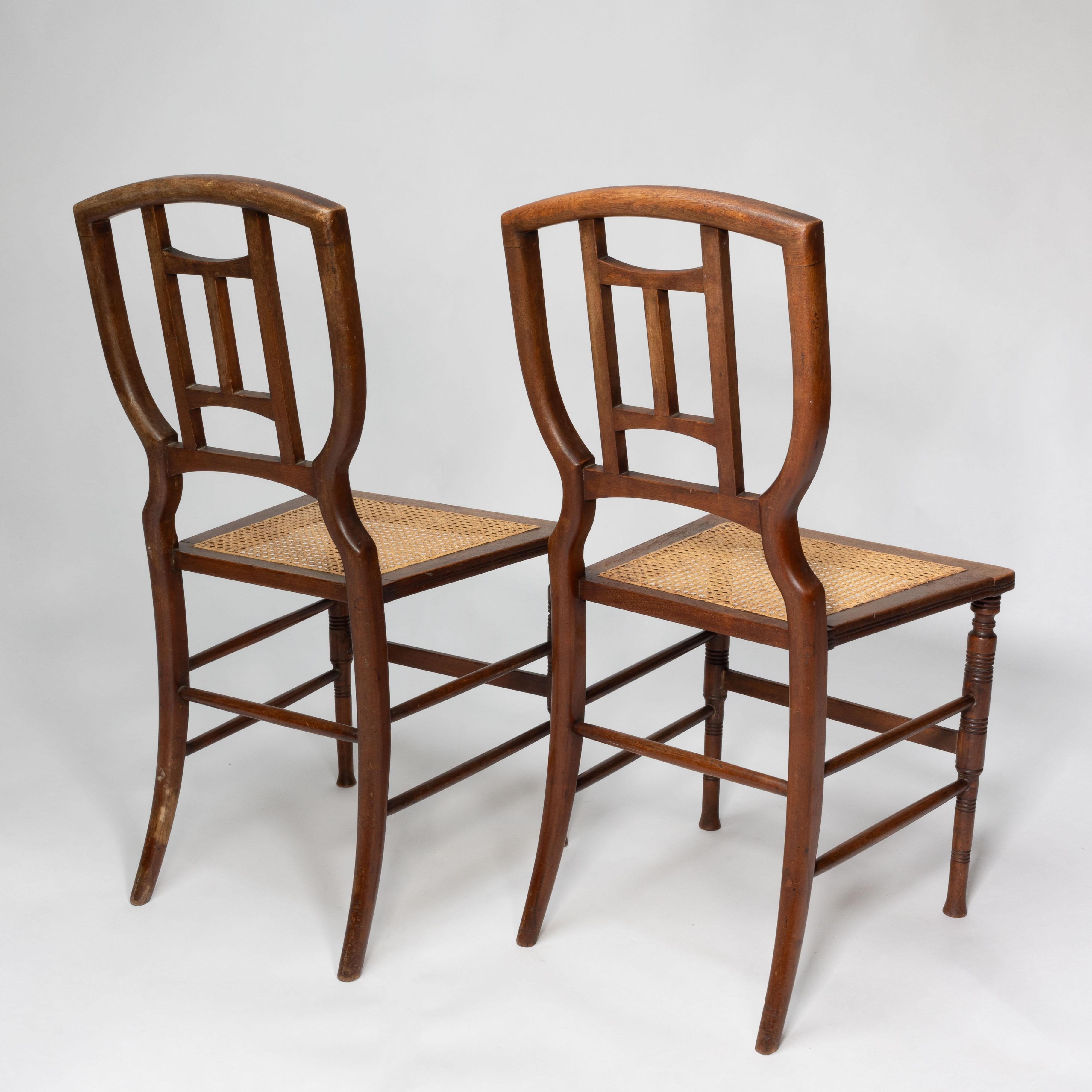 English H W Batley attr. Jas Shoolbred Pair of Aesthetic Movement cane seat beech chairs For Sale