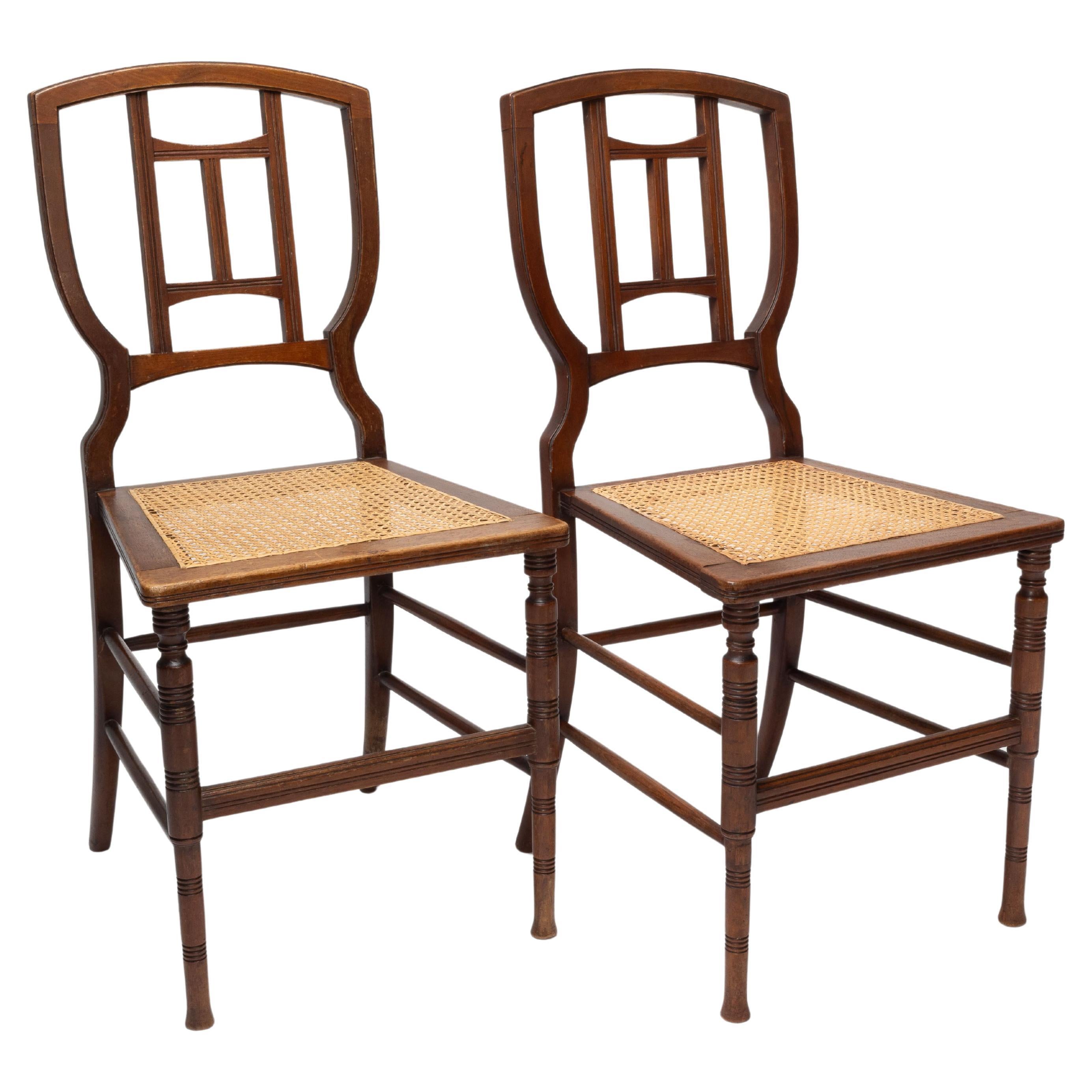 H W Batley attr. Jas Shoolbred Pair of Aesthetic Movement cane seat beech chairs For Sale