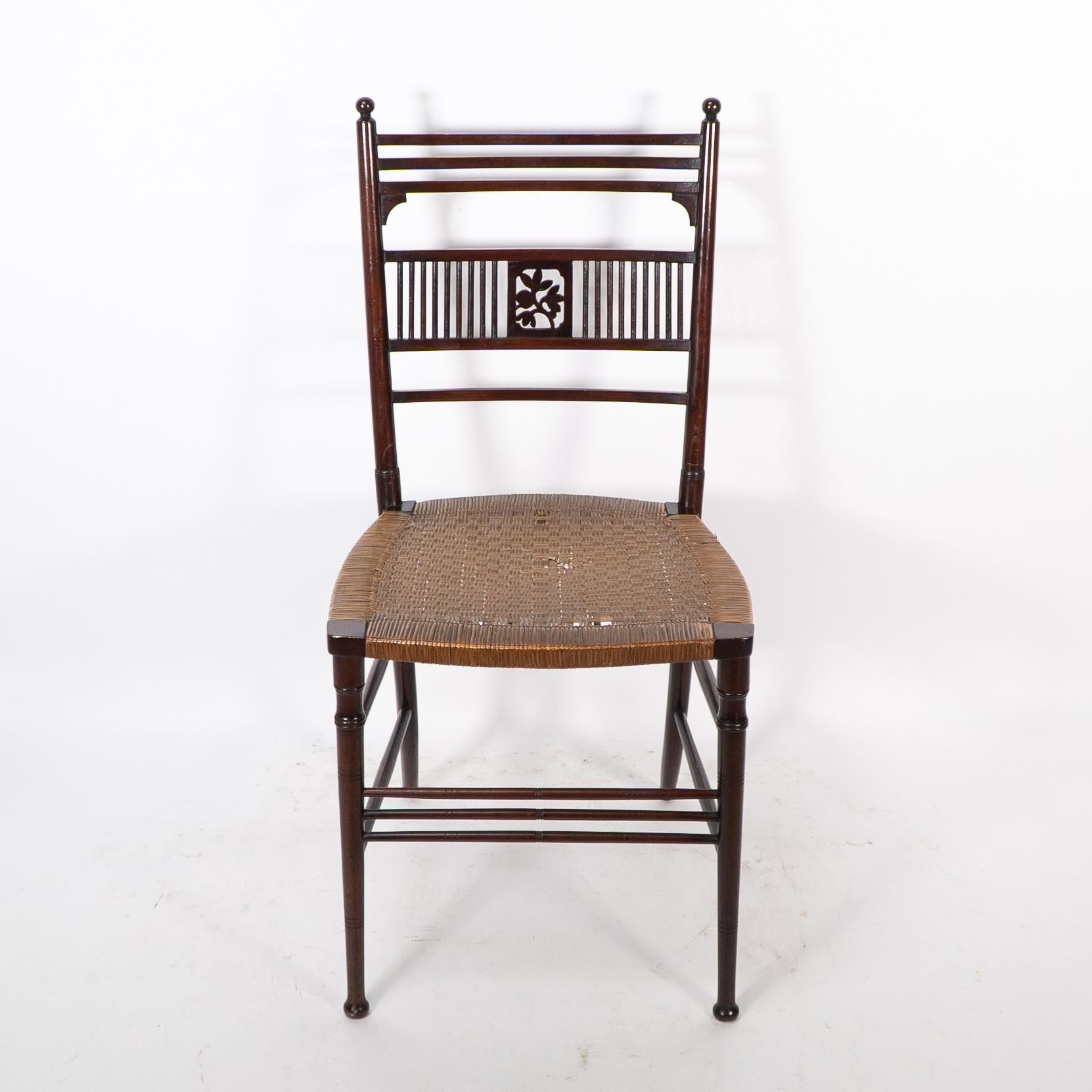 H W Batley for Collinson and Lock. A fine Aesthetic Movement side chair with pierced floral decoration to the back. Retaining the original cane seat with some minor losses and old stable repairs to the back legs above the seat.