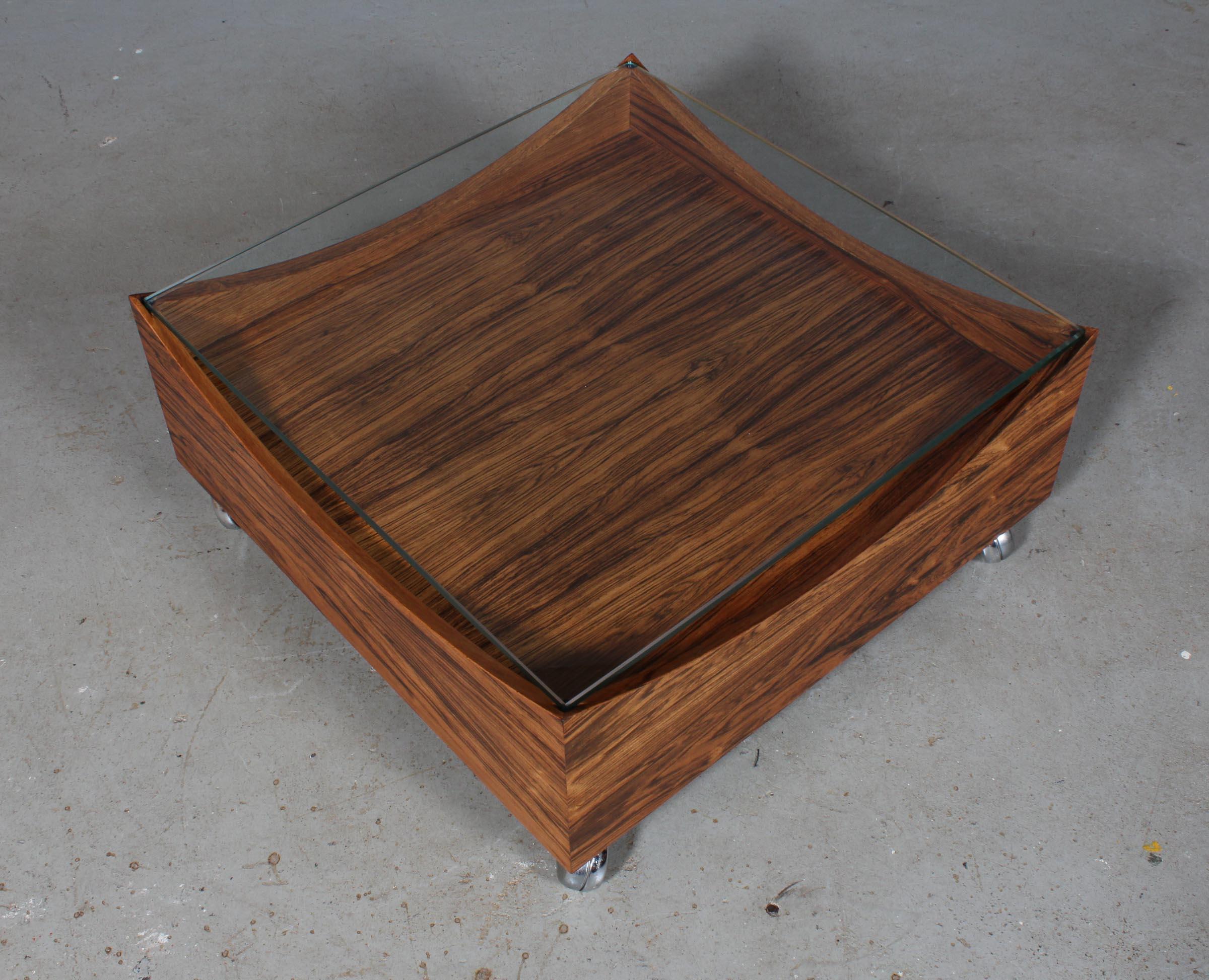 H. W. Klein coffee table in rosewood. Plate of glass. Mounted on wheels.

Made by Bramin.

 