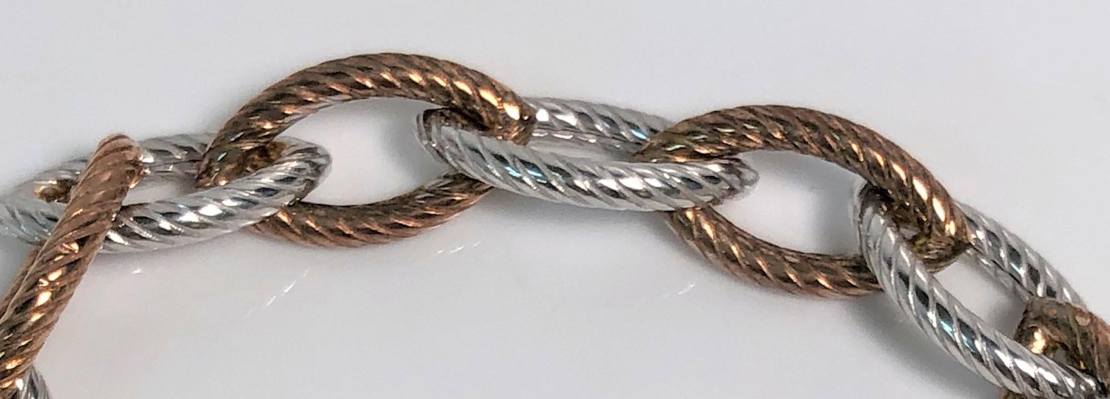 This bracelet is perfect for someone who wears mixed metal colors or just loves a different styled charm bracelet.  
The ribbed oval links alternate between a rose color and sterling silver.  
Perfect for a charm bracelet, combined with other