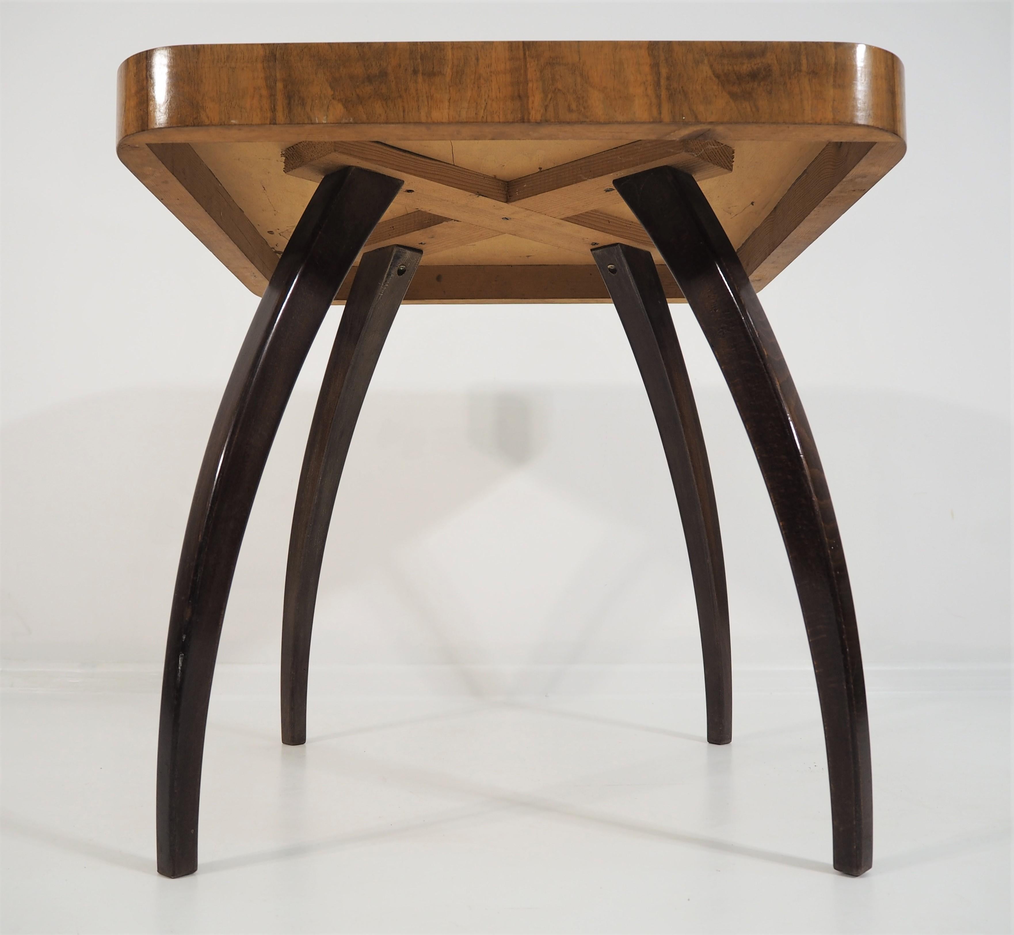Art Deco walnut side table. This adjustable dining table was designed and made in the circa 1955 in the former Czechoslovakia. It was designed by Jindrich Halabala for ÚP Závody. The material is a combination of solid wood and walnut veneer.