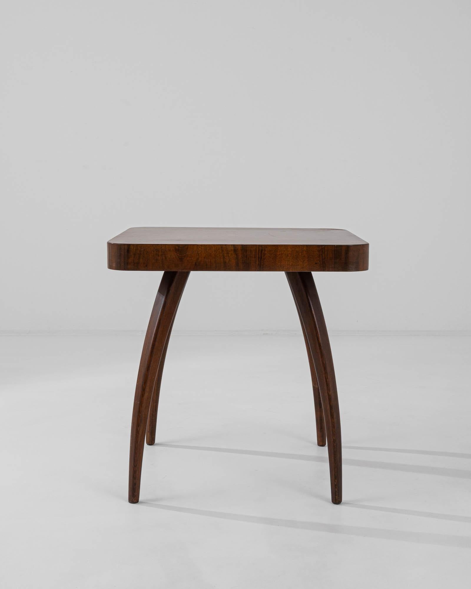 Designed by Jindrich Halabala, this iconic side table was produced in the former Czechoslovakia, circa 1930-50. Known as the ‘spider table,’ the H259 owes its name to the playful curve of bentwood beech legs. A decorative wood veneer is composed