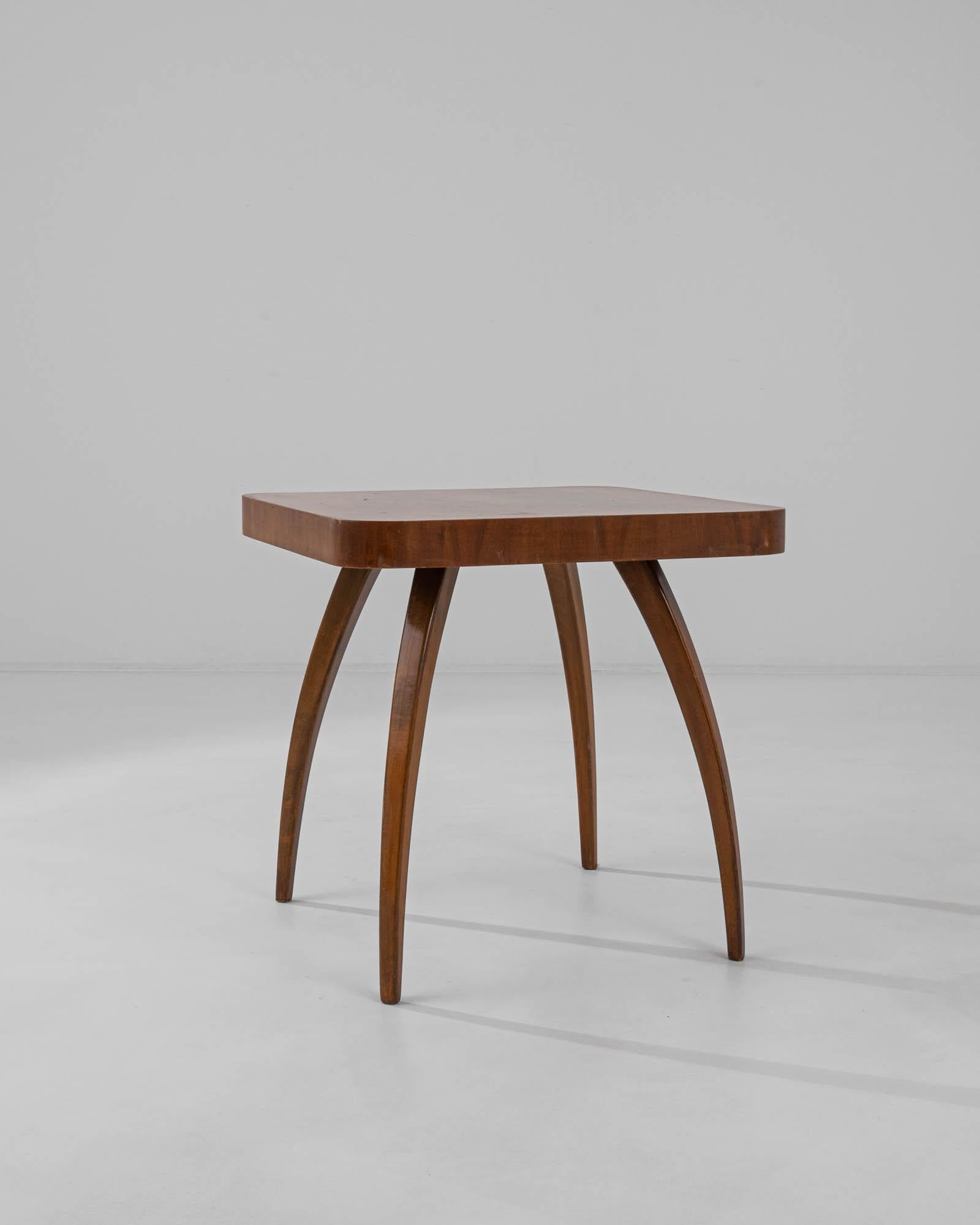 Designed by Jindrich Halabala, this iconic side table was produced in the former Czechoslovakia, circa 1930-50. Known as the ‘spider table,’ the H259 owes its name to the playful curve of bentwood beech legs. A decorative wood veneer is composed