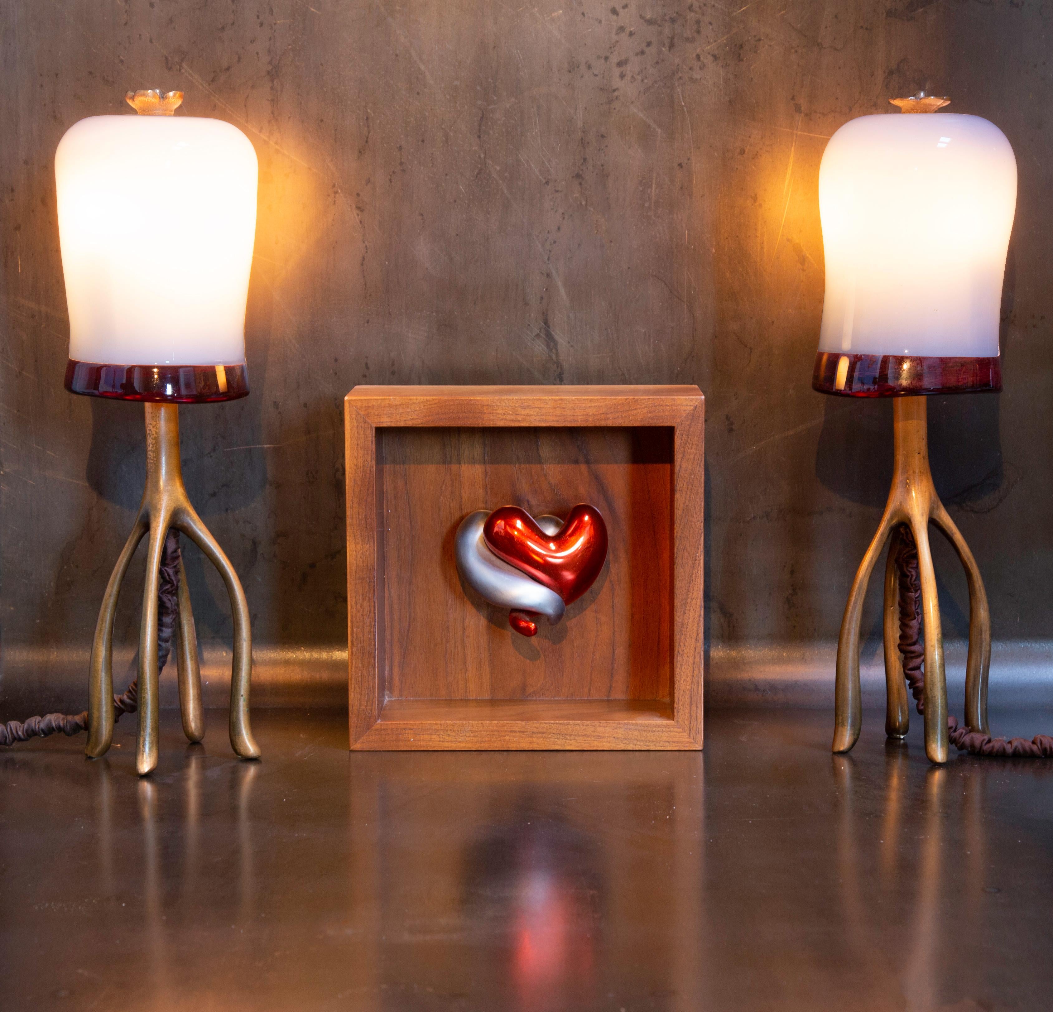 H57 Boudoir table lamp with a bronze finial in recycled cast bronze and hand blown glass with a deep oxblood lip wrap, by Jordan Mozer (b.1958). Made in Chicago, 2007. Measurements; 17” tall x 5” diameter (43 cm tall x 12.7cm diameter).

This