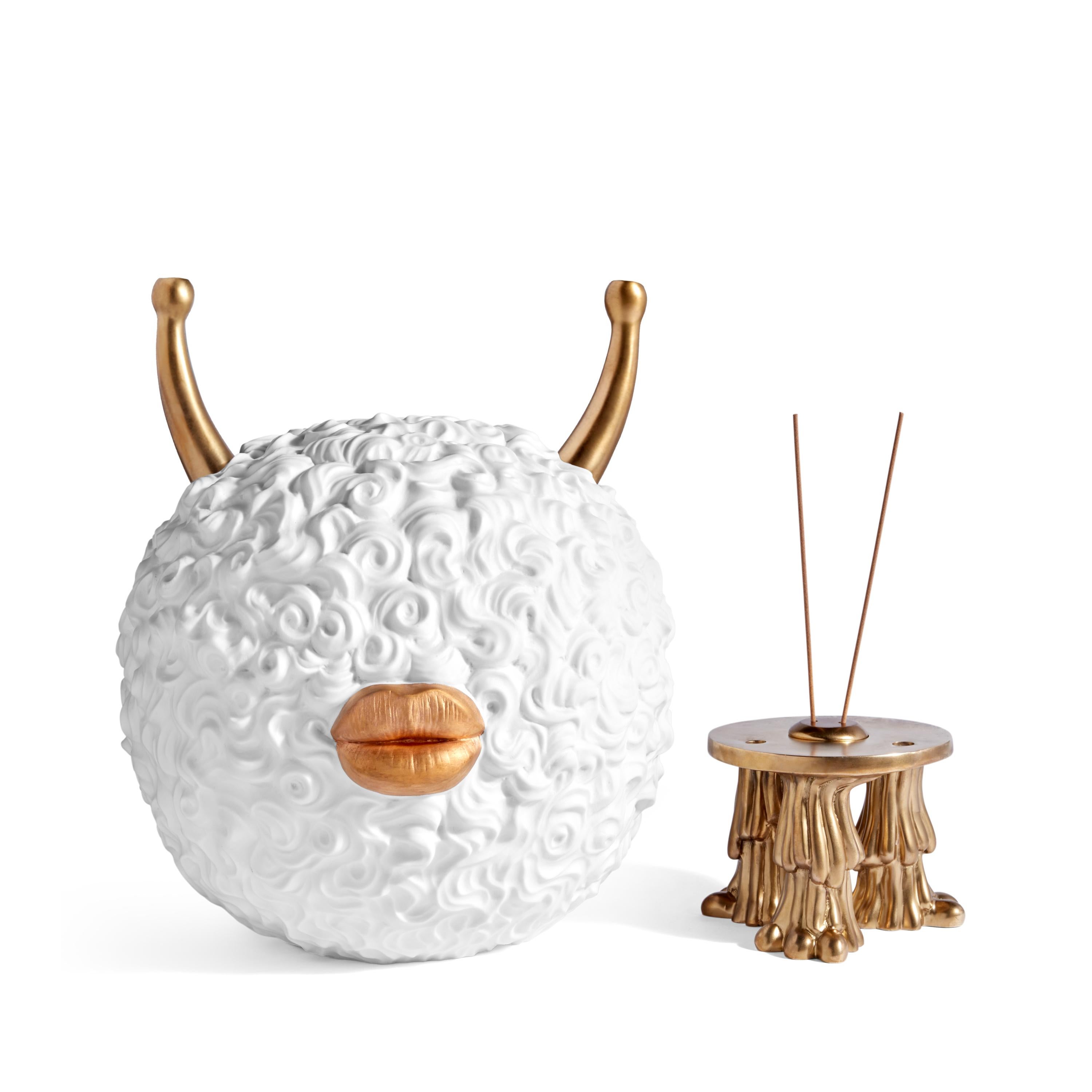 Light incense and conceal under the monster’s porcelain torso, as the incense smolders it’s fragrant smoke will be released through the creature’s brass horns. It's sculpted hair pushes porcelain to its limits creating a texture that is