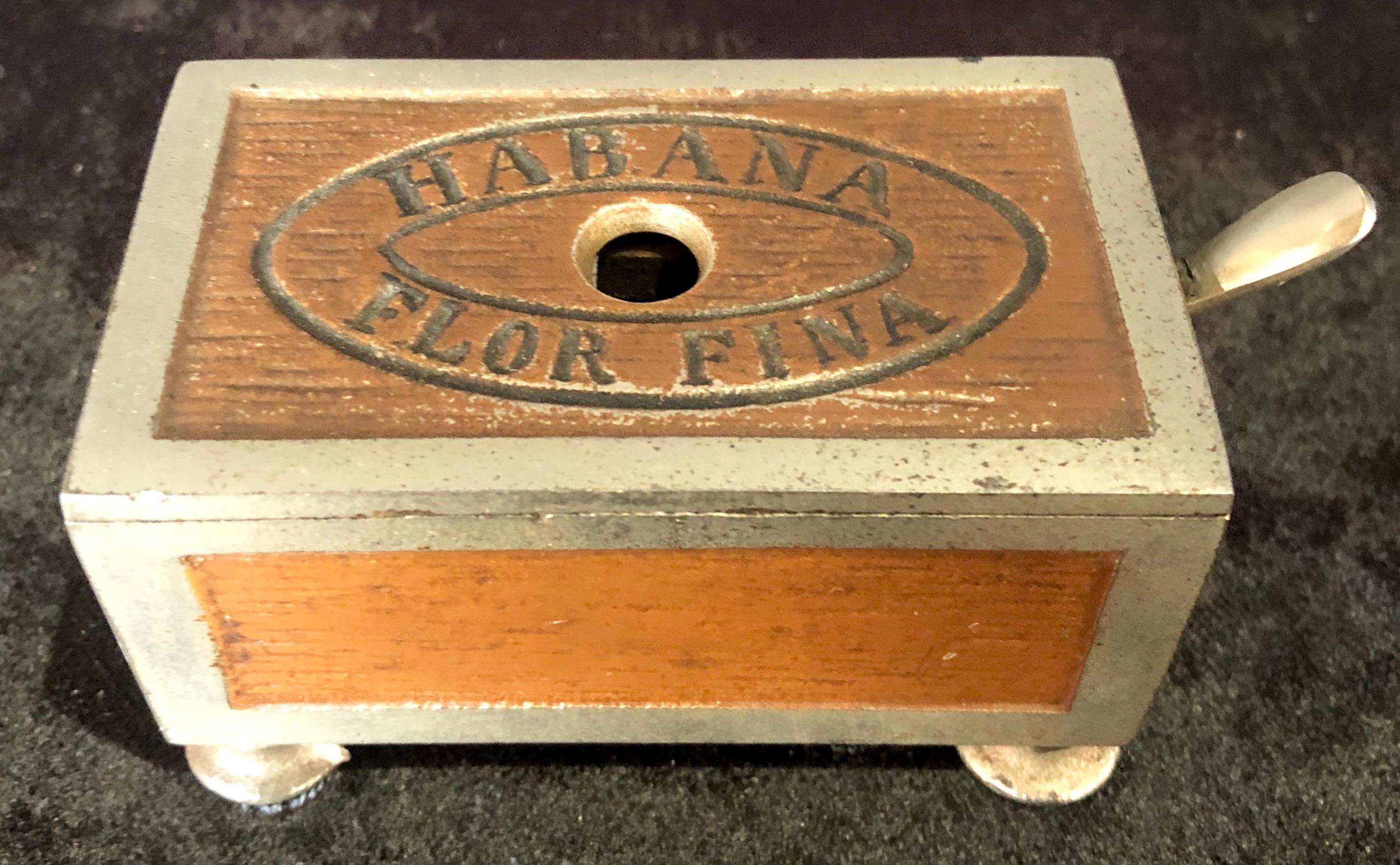 Habana small cigar box cutter.
Early figural cigar box shaped mechanical cigar cutter, with Habana Flor Fina incised into lid. This is simply as sweet as it gets. Germany; 1890 original paint
This is part of the personal collection purchased