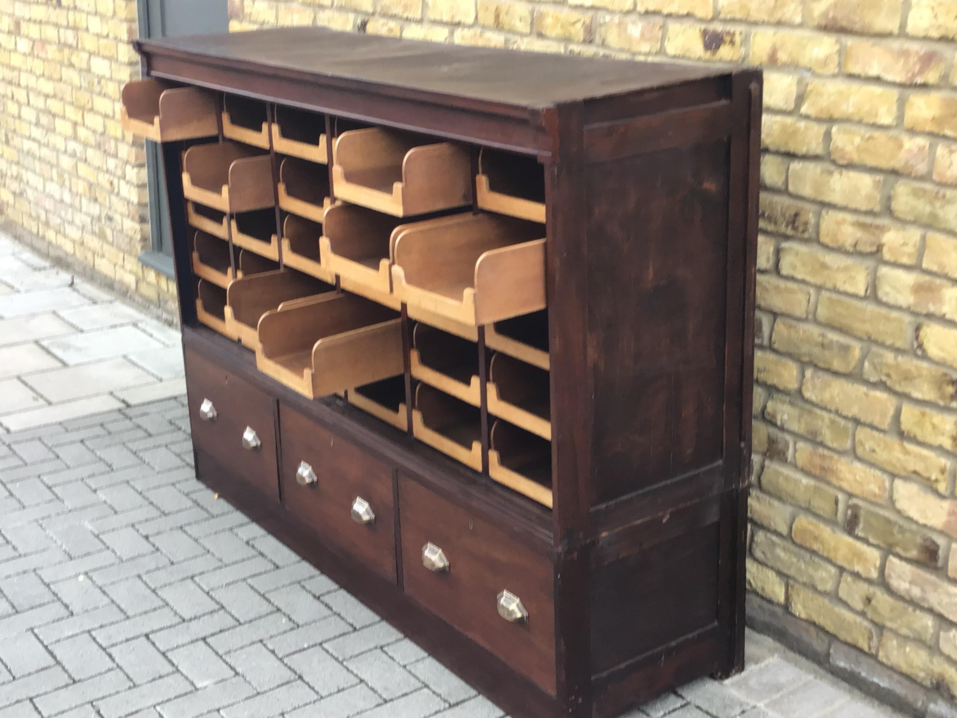 Magnificent early 20th century British mahogany haberdashery drapers display cabinet circa 1930, the
Unit spits into two. A set of 30 pull out draws in light oak and a collections of 3 large storage draws at the base.
Flexible with function.
 