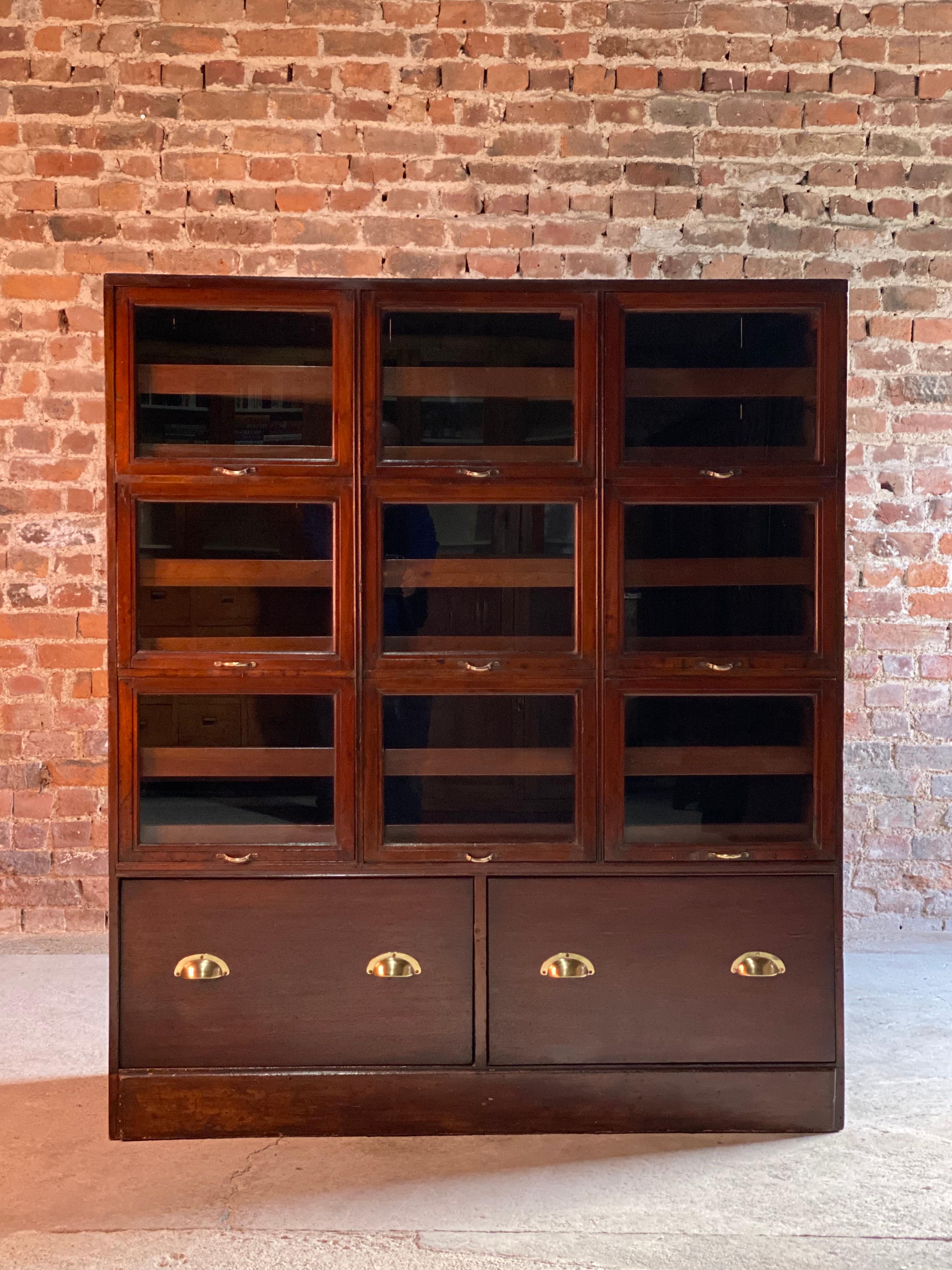 Haberdashery drapers shop display cabinet mahogany loft style, circa 1940 

We are delighted to this magnificent early 20th century British mahogany haberdashery drapers display cabinet circa 1940, the rectangular top over nine 'up and over' glass